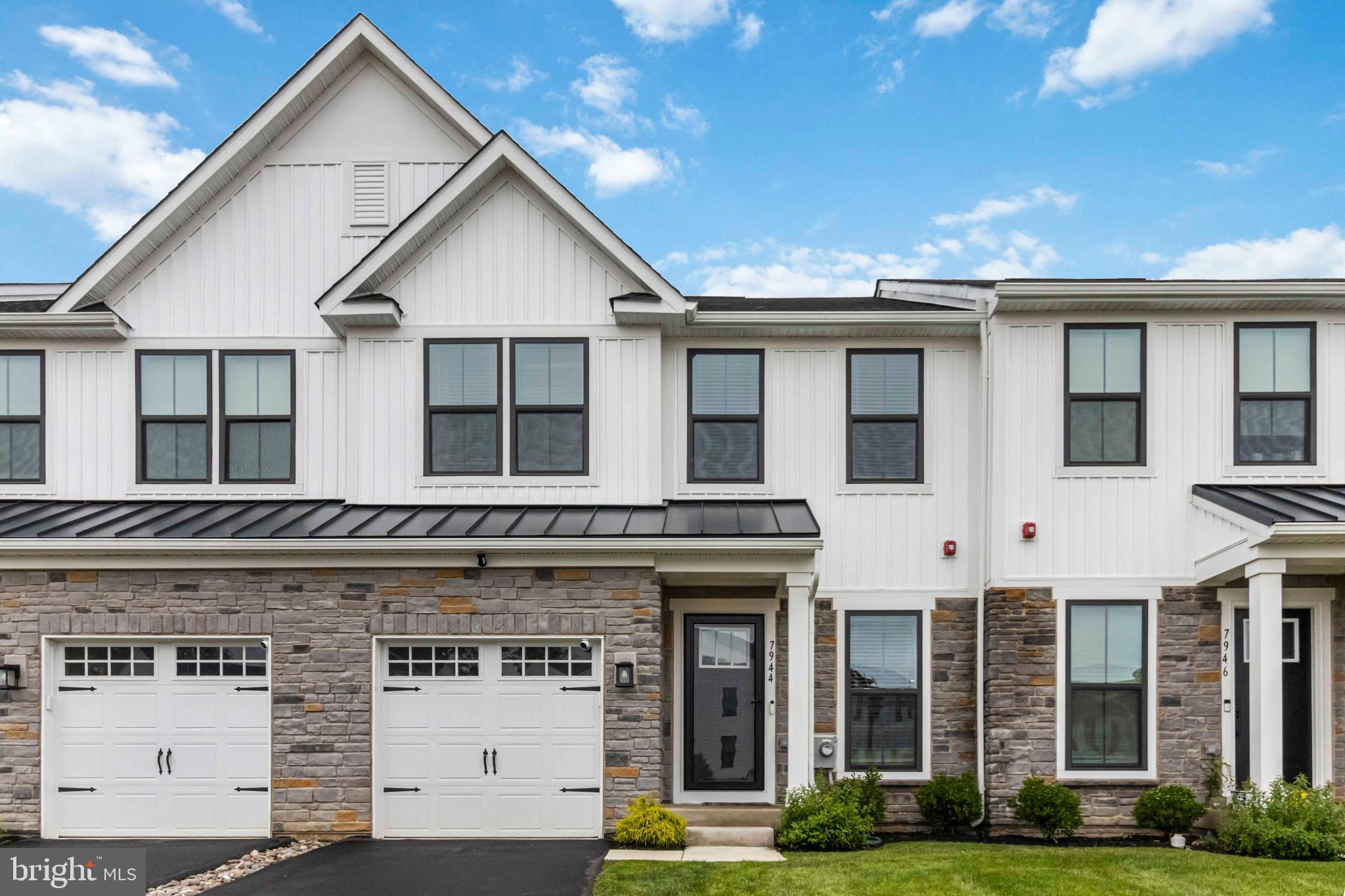 Modern Luxury Meets Suburban Charm in Ashbourne Meadows
Built in October 2023, this beautifully upgraded townhome in the highly sought-after Ashbourne Meadows community is where elegance, comfort, and convenience converge. With 2,570 square feet of finished living space, 3 bedrooms, 3.5 bathrooms, and a host of upscale features, this home offers the perfect blend of style and function in one of Cheltenham Township’s most desirable locations.
Step through the front door into the bright and inviting morning room, where sunlight pours in through oversized windows and a custom-crafted wood accent wall adds warmth and character. Whether you're enjoying a quiet cup of coffee, reading, or working from home, this space sets the tone for the thoughtful design that flows throughout the home.
From there, the open-concept layout leads into the heart of the home—a chef-inspired kitchen that combines beauty and functionality. Featuring quartz countertops, sleek white cabinetry, stainless steel appliances, a gas cooktop with a vented microwave hood, and a striking herringbone tile backsplash, the kitchen is anchored by an oversized island with seating for four. Just beyond, the dining area opens seamlessly into the living room, where a cozy gas fireplace creates a perfect gathering space for relaxing or entertaining. Sliding glass doors from the dining area open to a spacious composite deck, offering tree-lined views and a peaceful spot for outdoor dining or unwinding at sunset.
Downstairs, the fully finished walk-out basement expands your living possibilities with an extra-large family room, full bathroom, and direct access to the backyard and scenic community walking trails. Whether you're hosting guests, setting up a home theater, or simply enjoying a second living space, this level offers both comfort and versatility. Smartly designed storage areas—under the stairs, in the mechanical room, and at the front of the home—make seasonal organization a breeze.
Upstairs, the oak staircase leads to a stunning primary suite, complete with vaulted ceilings, a large walk-in closet, and a spa-like en suite featuring a walk-in shower and private water closet. Two additional bedrooms are thoughtfully positioned on the opposite end of the hallway, accompanied by a full bath and a convenient laundry room.
Located within the well-regarded Cheltenham School District, Ashbourne Meadows places you close to everything—yet offers the serenity of suburban living. Enjoy easy access to Greenleaf at Cheltenham, Willow Grove Park Mall, Tookany Creek Park, Curtis Arboretum, and Melrose Country Club. Commuters will appreciate quick connections to Route 611, the PA Turnpike, and regional rail lines, offering easy travel to both Center City and Northeast Philadelphia.
This home is more than just beautifully built—it’s intentionally designed for how you live. From the stylish finishes to the walkable community and prime location, this Ashbourne Meadows gem invites you to live fully, comfortably, and connected.
