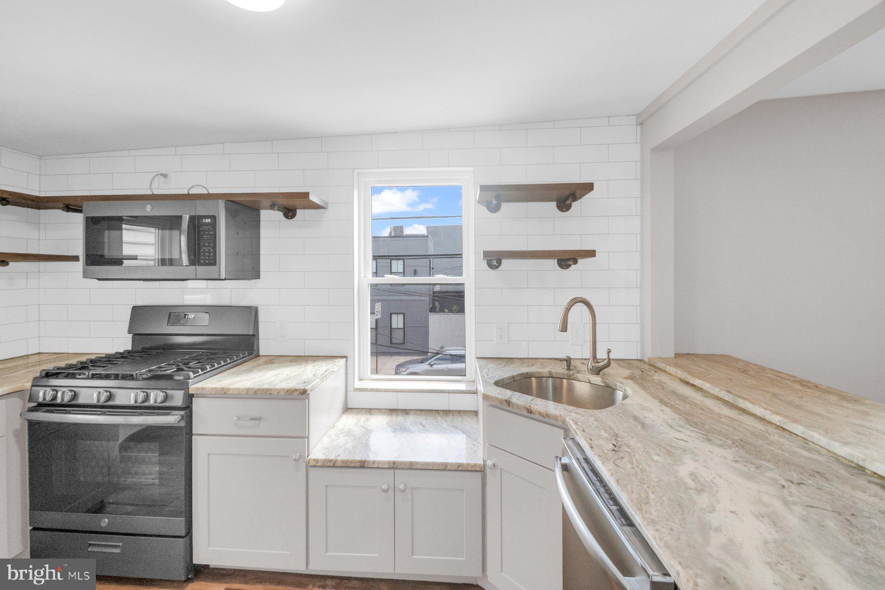 Newly updated RENTAL apartment located in Locust Point featuring a 1BR/1BA unit on the second floor.  Private entry into the open concept living space featuring an exposed brick wall with wood beam accents throughout, tons of natural light, and beautiful flooring.  The kitchen is stunning with stainless steel appliances, cabinets and open wall shelving, beautiful granite countertops, a subway tiled backsplash and a stainless sink under a pass through into the living room with breakfast seating. Down the hall is a spacious bedroom with a large closet and a newly remodeled full bath with a double sink vanity and a stunning walk-in shower. This unit also features two mini-split units for heating and cooling. This RENTAL is ready with everything you need to move right in.  All this and in close proximity to shopping, restaurants, and commuter routes.