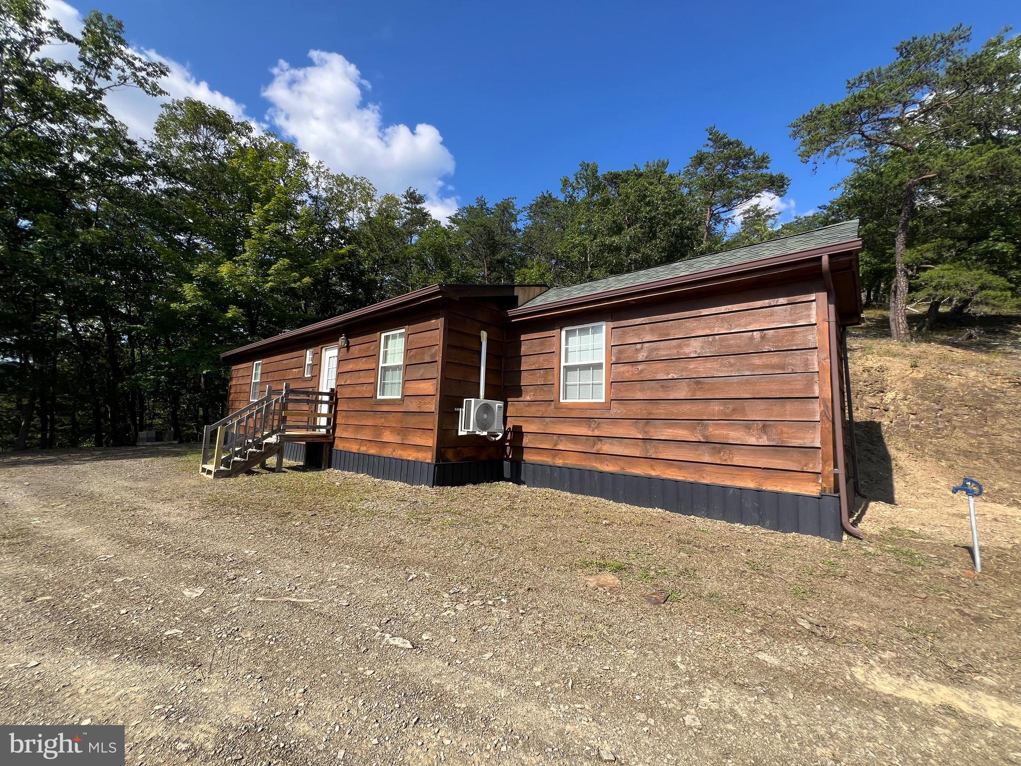 Looking for the perfect weekend getaway or want to downsize to a small house? This has it all! Ready to move into and work from home with NO interruption except the sounds of nature! Excellent hunting on this 16.39 acre wooded tract. Panoramic sunset views or enjoy your morning coffee from the perfectly positioned swing. There is a small stream on the property that is gushing at times and dry at others.
This cedar sided chalet is perched on a knoll that has a large flat area for enjoying the fire pit in the evenings while you're cooking over the traditional "mountain" grill." Smart" oven lets you turn it on from you phone and heat up while you're on way home! Huge stainless refrigerator. All applianced convey. Three mini-splits keep you cool in the summer and warm in the winter! 1400 gallon in-ground cistern. 200 AMP electric with DSL available via phone line and Fiber Optic available very soon. Approved septic. You will also have interest in the four acres lot near bottom of mountain, which has a large picnic shelter, rough kitchen and restroom for family and friends to gather, grill, and enjoy the beautiful mountain views.
And National Forest is within walking distance! Golf courses and public fishing within half hour. Lots of opportunities for outdoor adventure on your terms! Get pre-qualified and call for appointment today!