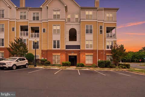 Photo of 2111 Highcourt Lane #201, HERNDON, VA 20170 (MLS # VAFX2332390)