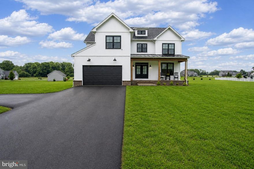 Welcome home to the perfect mix of fresh, modern design and laid-back country charm. Set on 1.4 acres in the exclusive Little Georgetown Estates, this like-new 5 bedroom, 2.5 bath modern farmhouse has everything you’ve been dreaming of-and more. From the moment you step onto the inviting full front porch, you’ll feel the warmth and personality this home offers. Inside, the main level is wide open and full of light, with gorgeous hardwood floors, custom built-ins, and stylish touches like wooden ceiling beams and a gas fireplace that anchors the cozy family room. The chef’s kitchen is made for real life and real entertaining, with an oversized island, gas cooking, tons of cabinet & counter space, and a walk-in pantry. The family room, dining & kitchen flow effortlessly from one space into the next. Need a quiet space to work from home or host guests? You’ll love the main-level bedroom or home office, privately tucked away behind a rustic sliding barn door. There is also a convenient mud room just off the garage with a built in bench and coat station. Upstairs, the spacious primary suite offers a relaxing escape with a tray ceiling, a huge walk-in closet, and a spa-like bath featuring dual vanities, a freestanding soaking tub, and a walk-in shower. There’s also a loft area that works great as a playroom, homework space, or bonus lounge—and the secondary bedrooms are all generously sized, giving everyone room to spread out. The laundry room is conveniently located on the bedroom level as well. There’s also a full unfinished basement with rough-in for a future bathroom—ready when you are to finish it your way. Outside you will love the large covered rear porch—ideal for weekend barbecues, morning coffee, or just unwinding. Located in the Spring Mills school district, this home is packed with quality finishes, thoughtful details, and room to grow.