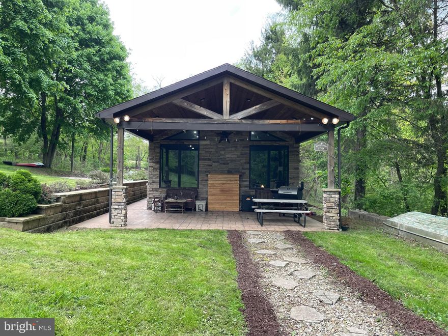 Laurel Highlands home minutes away from Yough Lake and Dam, Nemacolin Resorts including Golf, Dining, Casino and more!!!  This adorable home has a rustic cabin feel in the original home and a twist of modern with the addition.  Enjoy a vaulted ceiling with stack stone, large updated bathroom with custom tile work and a covered patio completely private!!!     Basement is finished under the addition with a large size family room, laundry room and walk-in closet.    Served with public water which is a great find in the mountains.  Fireplaces in the living room and bedroom plus supplemental pellet stove in basement.  Great lot which is surprisingly private for being on the main road, YOU WILL HAVE TO MAKE THIS TOUR A PRIORITY.