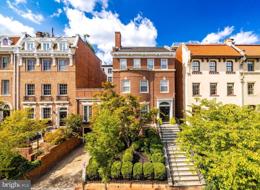 An Elegant Kalorama Residence:
Evoking the timeless character of a London townhouse, this distinguished 1911 residence blends classic grandeur with contemporary ease. Graceful proportions, soaring ceilings, intricate moldings, and rich hardwood floors define its character, while a thoughtfully reimagined floor plan welcomes modern living and effortless entertaining.
A stately entrance hall introduces exquisite architectural details including coffered ceilings, wainscoting, pocket doors, and a grand staircase. Six fireplaces lend warmth and atmosphere throughout. The sunlit front reception room opens seamlessly to a spacious living room and a banquet-sized dining room, creating a refined setting for gatherings. The bright white kitchen with a center island, breakfast bar, and adjoining family room invites relaxed everyday living. Walls of windows and French doors connect every main level space to expansive flagstone terraces and a beautifully landscaped garden, ideal for indoor and outdoor enjoyment.
The second floor is devoted to the luxurious primary suite, featuring an oversized bedroom, spa-like bath, dual closets, a private roof deck, and a handsome paneled library. Upstairs, the third floor offers three lovely bedrooms and two full baths.
The light-filled lower level, with a separate side entrance, includes a family room, full bath, wine cellar, ample storage, and direct access to the attached two-car garage.
Additional highlights include an elevator serving all levels, six fireplaces, a large terrace, and garage parking for two cars plus additional driveway space. The garage is equipped with a level 2 charger for electric vehicles. Perfectly positioned in Kalorama, one of Washington’s most coveted neighborhoods, this remarkable home offers easy access to Rock Creek Park, fine dining, boutique shopping, Metro, and Georgetown.
Offered at $5.7 million.