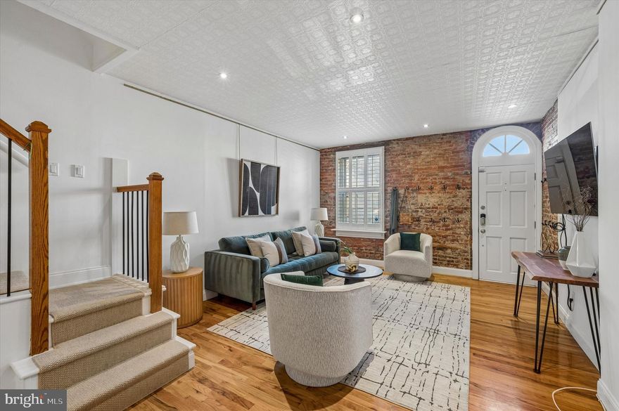 Welcome to 721 S. 3rd Street—a beautifully updated Queen Village home in the highly sought-after Meredith catchment. This townhome offers the perfect blend of original character, comfort, and move-in-ready convenience. The main level immediately impresses with an arched doorway, exposed brick, high ceilings, and hardwood flooring. The open kitchen was thoughtfully refreshed a few years ago with updated flooring, LG stainless steel appliances, and modern flat-front wood cabinetry. A sliding patio door leads to a private outdoor patio, ideal for entertaining or low-maintenance urban gardening. A charming powder room is tucked at the top of the basement stairs, offering both convenience and privacy, and features exposed brick, open shelving, and an eye-catching silver tile accent wall. The second floor houses the primary suite, which is both functional and inviting, with west-facing sunlight. It features a customized walk-through closet with two 72-inch Robern medicine cabinets, as well as a brand-new European-style bathroom complete with white hexagon tile flooring, subway tile, and a clawfoot soaking tub. This level also includes an additional bedroom and a fully renovated laundry area with a new LG washer and dryer, a butcher block folding countertop, and abundant storage. Upstairs, the third floor offers exceptional flexibility, featuring another spacious and bright bedroom with a dormer window, a full bath with a pedestal sink, and a dedicated hallway nook—perfect for today’s work-from-home lifestyle. Capping it all off is a sun-drenched rooftop deck, providing the perfect setting for morning coffee or evening gatherings. The basement offers good ceiling height and provides space for more than just storage. For peace of mind, both the water heater and HVAC system have been replaced within the past year, and a mini-split system was added to the third floor for additional comfort during the hot summer months. For those nights when cooking feels like a chore, there’s no shortage of amazing restaurants nearby, including Cry Baby Pasta, Southwark, Famous 4th Street Deli, and Bridget Foy’s, just to name a few. Queen Village is also a treasure trove of small, local businesses—from bike shops to coffee shops to vintage housewares. Homes in this location and condition rarely become available—don’t miss your opportunity to see it before it’s gone!