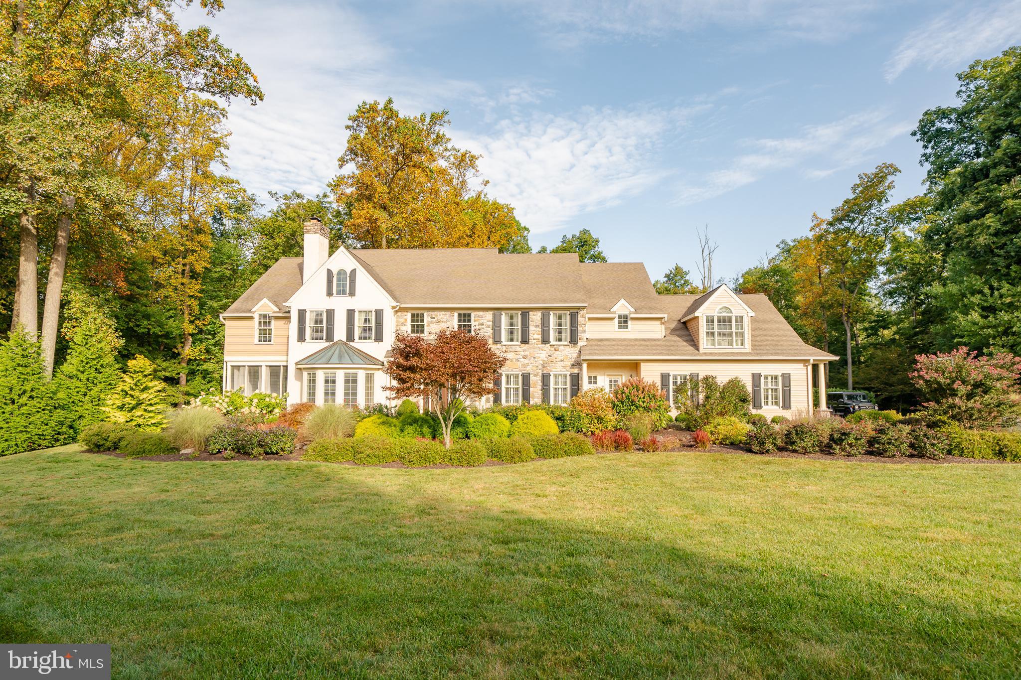 Welcome to the quaint neighborhood of Glenwood Estates. This hidden gem of Chester County is unsurpassed country living at its best. This former model home offers many amenities and upgrades for the most discerning buyer. Located on 4 partially wooded acres and cul-de-sac, this Traditional home boasts 5/6 bedrooms, 5 full baths and 2 half baths. The main level with custom coffered ceilings, includes an oversized double family room with a wood burning fireplace, a formal living room with a gas fireplace, dining room, mudroom with custom cabinetry & kitchen with a oversized custom island which offers a chef’s dream with Jenn Air appliances including 4 ovens total, built in coffee/espresso machine, induction cooktop & 2 dishwashers. The second level includes laundry facilities, 3 bedrooms with 2 ensuite bathrooms as well an oversized third level bedroom with a full bathroom. The primary master suite with gas fireplace on the second level includes a bonus room with a private balcony, office area, custom dressing room with built ins, island and vanity. The large master bathroom includes an oversized shower with a steam system, heated floors, claw tub, gas fireplace and custom cabinetry. The finished walkout lower level offers ample living space, a kitchenette, bedroom, full bathroom and a bonus room currently used as a home gym with a separate entrance from the garage. Looking for outdoor entertaining? This home offers it all – beautiful outdoor oasis with a heated, saltwater pool and custom paver patio with lighting and gas fire torches, an oversized deck with trex decking and railing, a upper paver patio with stone fireplace, custom outdoor kitchen with built in grill, fridge and sink make this a true resort style home. 4 sets of French doors take you to the outside deck or the large screened in porch with ceiling fans ready for warm summer evenings. Pickleball anyone? A private, personal pickleball court is at your disposal off the screened porch area. Extensive professional landscaping, hardscaping, lighting and Sonos ready outdoor speakers make the space inviting and ready for summer use. 3 zone HVAC systems, 2 hot water heaters, whole house water conditioning system, reverse osmosis water system, speakers throughout home for Sonos are just a few extras. The oversized back entry 3 car garage offers an epoxy floor and a bump out for a workspace. This home is truly a must see for luxury living. Photos do not do this home justice.