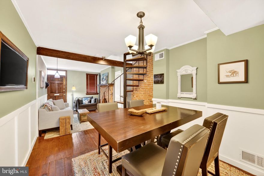 Welcome to 11 E Wheeling St, a beautifully updated home that blends classic charm with modern conveniences. Thoughtfully refreshed and move-in ready, this residence offers an open, light-filled layout ideal for everyday living and entertaining. Original architectural details meet contemporary finishes throughout, creating a warm, inviting atmosphere from the moment you arrive.

Step inside to an airy living area with abundant natural light, clean lines, and rich hardwood floors that flow seamlessly throughout all 3 levels of this amazing home. The heart of the home is a thoughtfully designed kitchen featuring sleek dark cabinetry, granite countertops, stainless steel appliances, and a practical layout that makes cooking and hosting effortless. Ample storage and convenient counter space provide both style and function. The open shelving is always a hit with guests, and the french patio doors both open to the flagstone rear patio.

Upstairs, the bedrooms provide peaceful retreats with generous closet space and exposed brick finishes. The soaring 2 story primary suite offers a comfortable, private setting to unwind, and the bathroom has been updated with modern fixtures and tasteful tile work for a clean fresh feel. The loft bedroom on the 3rd floor is versatile and can easily serve as a home office, guest room, or playroom to suit your lifestyle.

Quiet outdoor living is a highlight: enjoy a low-maintenance yard perfect for morning coffee, grilling with friends, or a small garden. A private patio and second floor roofdeck extends your entertaining space and both offer a quiet spot to relax. Street parking is easy with your Zone 9 parking pass. The full height, semi-finished basement serves well as the laundry drop spot and extra storage space add convenience for daily life.

Located in a desirable, walkable area, this home is located between S. Charles and Light Sts. and is amazingly close to a variety of restaurants, coffee shops, and local amenities. Commuters will appreciate easy access to major routes and public transit options. Camden Yards is not only home to the major league Orioles, there is an easy to catch commuter train as well on premises. Whether you’re drawn to weekend markets, nearby parks, or vibrant neighborhood events, this location delivers both convenience and community.

Additional updates include modern systems and tasteful finishes that combine to minimize maintenance and maximize comfort. This home is perfect for first-time buyers, professionals seeking easy city access, or anyone looking to downsize without sacrificing style.