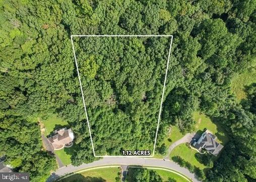 Build the home of your dreams on this 1.12-acre estate lot. This lot allows for a full walk-out basement with a potential in-law suite and a gravity septic field. This partially wooded lot is located in the beautiful Villages of Elk Neck community. Enjoy the secluded feel of the neighborhood, with the convenience of being close to parks, marinas, local downtown restaurants, and shops. The property is 15 minutes from Elkton & North East and 45 minutes from Wilmington, DE. Bring your custom builder. No builder tie-in. Buyer/Builder should consult HOA docs for community guidelines. HOA docs are provided in the documents section. Contact Aspen Property Mgmt for updated HOA information. The Perc plan was approved for a 4 BR home with a recorded plat and previously permitted for a 5,284 square foot home with private sewage and water supply. This lot had a final grading plan and survey done by Norther Bay Land Planning with standard erosion and sediment control plans.
