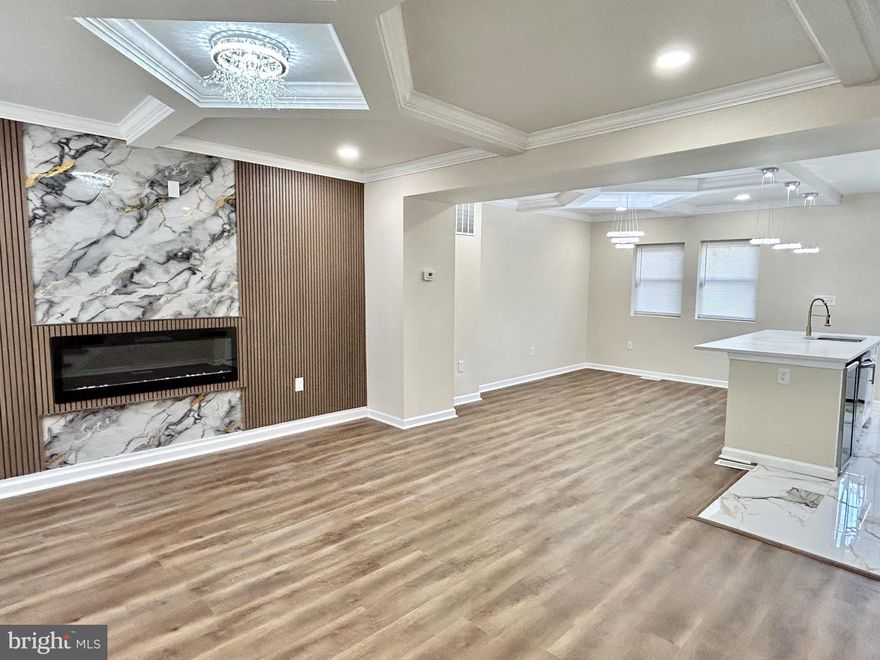 Welcome to this stunning Baltimore renovation conveniently located in the Belair Edison neighborhood! Step in to the breathtaking main level that effortlessly combines comfort and luxury. You are greeted with a bright open floor plan as you enter the living room, featuring stylishly designed coffered ceilings and a chic fireplace insert to compliment the custom accent wall. The living room flows seamlessly into the dining area, perfect for entertaining or enjoying a meal. The heart of the home is in the gourmet kitchen featuring sleek quartz countertops,  a spacious island, stainless steel appliances, custom cabinetry, as well as luxurious gold accents. Off of the kitchen allows convenient access to the fenced rear yard. Upper level boasts three carpeted bedrooms along with an elegantly finished full bath. Fully finished lower level offers a versatile space that blends comfort and functionality, including a cozy fourth bedroom, contemporary full bath, laundry area, and walkout steps to the rear yard. This home maintains classic charm with thoughtful modern upgrades. Come take a look at all this home has to offer!