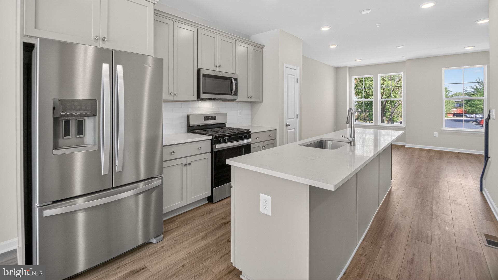 Most affordable new townhomes in the heart of Montgomery Village – move in ready!
Welcome to the Abbey—a thoughtfully designed, open-concept townhome where style meets everyday convenience. From the welcoming foyer to the light-filled living spaces, every detail is crafted for comfort and functionality.
• Entry-level bedroom with full bath – perfect for guests, parents, or a private home office
• Bright and sunny second-floor living area featuring a spacious family room with sliding glass doors to your private deck
• Gourmet-inspired kitchen with a generous center island, ample cabinetry, and a separate dining room for both casual meals and formal gatherings
• Two upper-level bedrooms, each with its own bath and generous closet space for storage and organization
• Separate laundry room and additional hallway closet on the upper level for added convenience
• Rear-load garage plus driveway for extra parking
• Open-concept layout designed to maximize natural light and create an inviting flow through every floor
Blending modern finishes, a versatile floor plan, and an unbeatable location, the Abbey offers the perfect place to call home in Montgomery Village.