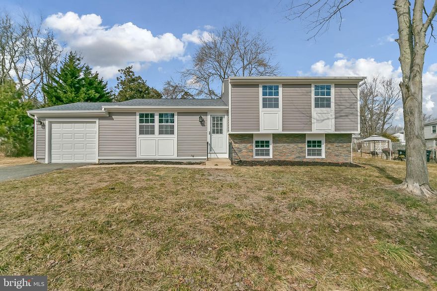 TASTEFULLY REMODELED FROM TOP TO BOTTOM, THIS HOME WAS DESIGNED WITH TODAYS BUYERS IN MIND!! This spacious home welcomes you with an open layout on the main level, flush mounted recess lights make this a bright, inviting space!.. Luxury vinyl plank flooring leads from large living room to dinning area and updated kitchen which features dynamic backsplash and quartz counter combination, designer pendant lights over large center island and new stainless steel appliances!. Large sunroom off of kitchen could be used as separate dinning room or additional living area.. Upper level bedrooms with lvp flooring, new doors and lighting!. Fully updated bathrooms with popular, yet unique, tile choices!. Lower level also features lvp flooring and recess lights, separate bedroom!. Fresh paint throughout!. ALL NEW ROOF, SIDING, AND HVAC!! Conveniently located near shops and dining and a short drive to DC, NOVA, and National Harbor, this home wont last long, schedule your showing today!!