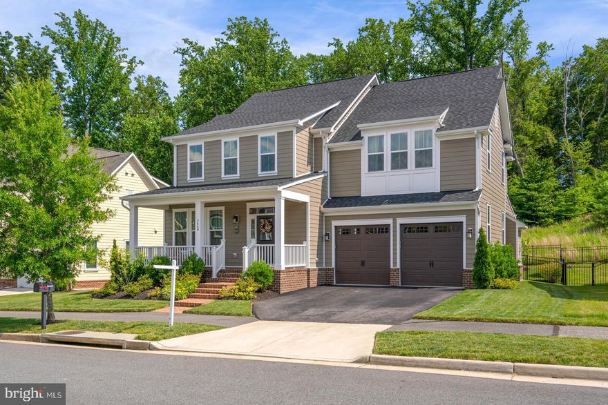 Quick Move-in Home  This is the popular Berkley floor-plan with triple porches,  a fenced rear yard and over 4425 finished square feet of living space. What makes this home unique is that it sits on a nine thousand square foot  NV Homes premium lot!   You you get  three finished levels, a home with 9 ft ceilings throughout, wood floors,  tile in the kitchen, a stunning upgraded tidewater trim package, five  true bedrooms, and four and half baths. This is one of the original  Southern Style Tidewater Designed homes and the most popular floor-plan-in  Potomac Shores. There is stone fireplace in the extended family room, large center island, cream colored cabinets, stainless steal appliances,  granite counters, a private office, mud room, four large bedrooms upstairs with three full baths, and the lower level has a. Rec room, bar with dishwasher and wine fridge, a full bath, huge bedroom, and storage room  with a walk-up exit to the fenced rear yard. This is a gorgeous home! The $180.00 HOA monthly fee  includes 150/150 internet, trash, snow removal, the gym, pool, and social events and five miles of nature trails.  Potomac Shores has a social committee that organizes meet-up events. There are many clubs, such as a Garden Club, Book Clubs,  Wine & Beer Clubs, Cigar Meet ups. events and classes for all ages. The Potomac Shores VRE and future town center are anticipate within the next year or two.