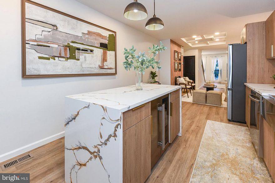 Hurry, this fully renovated 3-bed, 3.5-bath townhome will not last long!
Experience city living at its finest in this stunning, remodeled townhome just steps from iconic Patterson Park. Surrounded by neighborhood favorites—trendy coffee shops, local restaurants, and lively community vibes—you’ll be in the heart of one of Baltimore’s most desirable and walkable locations.
This home has been rebuilt from top to bottom with modern finishes and thoughtful conveniences. Step inside to an open floor plan, featuring an inviting accent walls, custom iron railings,  tray ceilings, custom lighting, and a sleek heat-emitting electric fireplace. Every detail crafted with style and sophistication.
The chef’s kitchen with custom cabinetry, premium appliances, and a built-in wine chiller—perfect for entertaining or a quiet night-in. Just outside, find a private patio offering a cozy retreat for dining al fresco or just relaxing outdoors.
Upstairs, each bedroom is designed as a suite, with its own bathroom, combining comfort and privacy. The luxurious primary bedroom boasts a spa-inspired en-suite bath, and dual closets. 
Convenience shines with a high-end stackable washer and dryer on the upper level. Plus, the water heater and washer are equipped with advanced flood protection which directs water to the sump pump in the basement—protecting your investment.
The fully finished walk-out basement provides additional living space, versatile, and complete with a Jack-and-Jill bathroom—ideal for guests, a home gym, or a cozy media room.
This home is not only beautiful, but also built for peace of mind: all work is fully permitted and city-code compliant, featuring brand-new plumbing, a new sewage line, updated 200-amp electrical service for today’s appliances/devices, new BGE meter, new windows, and a new roof.
With its unbeatable location, high-end finishes, and top-quality upgrades, this Patterson Park treasure is truly move-in ready and built to impress. Come see this beauty for yourself and don’t miss the chance to call it yours! 
**The Seller is generously offering to COVER BUYER CLOSING COSTS, making this property even more attractive and affordable. ** Submit your best offer today!