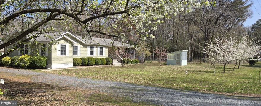 A perfectly situated, water-oriented, turnkey, rancher with a piece of country is ready for your enjoyment.  Produce your own vegetables, flowers or the like in the already established rear garden beds, collect your peaches, pears and other fruits from fruit bearing trees. Start your plants early in an enclosed greenhouse/produce stand.  A second greenhouse area is framed and ready for a canopy.  Utilize the two recently fenced in areas with separate gated access as needed.  A large storage shed with electric could be your workshop. An additional outbuilding is available within the farm fencing for your gardening tools and has room for animals. Store your trailable boat under the carport when not using it on the navigable Choptank River from Ganey's Wharf waterfront park and boat launch. Ganey's Wharf is within 1/2 of a mile of your mini homestead! Relax on the front porch or rear landing to take in the views. Mature growth woods exist on the sides of the property and across the street. Within home is a primary bedroom suite with a jacuzzi, separate shower, and a walk-in closet. A second bathroom, located off the hallway to two bedrooms, divides bathing area from toilet area (water closet) and includes a linen closet. The two hallway bedrooms include lighted ceiling fans.  Also, off of the hallway is a large utility room with a washer and dryer. A fourth bedroom/office contains built in cabinetry. The primary bedroom and the fourth bedroom/office are located on one side of home while the two other bedrooms are on the opposing side of home offering privacy with a central great room and eat-in kitchen between. The property is serviced by Choptank Electric and Fiber. A subscription ready security system is in place. All appliances, window treatments, runner, carpet, some furniture, some garden tools, and grills are included in this sale.  Don't be late.  It is time to prepare your gardens and get ready to take in the views from the waterfront park and all that you can experience from the scenic and bountiful Choptank River.  Just minutes from Easton (20), Denton (15), Cambridge (35), and tax-free Delaware shopping by car.  Annapolis is 1 hour by car.