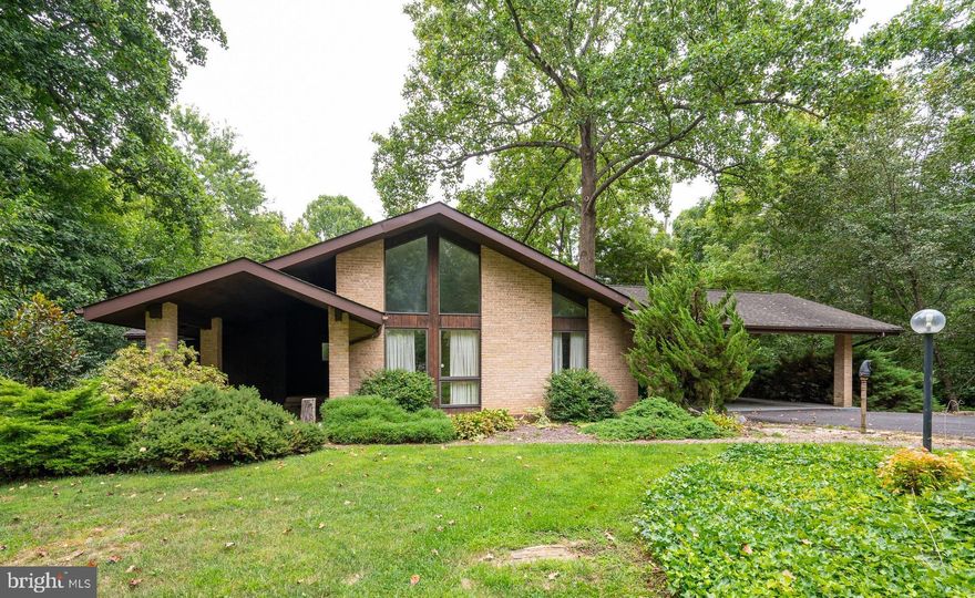 This spectacular home is one of a kind! You will not find another property like this one in all of the Eastern Panhandle. It sits on huge (2.01) acre lot with beautiful mature trees and landscaping. It's wonderful location is just minutes from I-81, WV University Hospital, Downtown Martinsburg and farm markets with their fresh fruits and vegetables and panoramic views. The interior features over 3000 sq ft of living area, a floor to ceiling brick fireplace in the great room, a formal living and dining room with vaulted ceilings and 3 large bedrooms. The finished basement offers much more room to expand. This home is in need of some cosmetic love, but just look at the potential beyond that!. Schedule your appointment, come see this Mid- Century Modern home and fall in love!! Start renovations now and watch your investment grow!