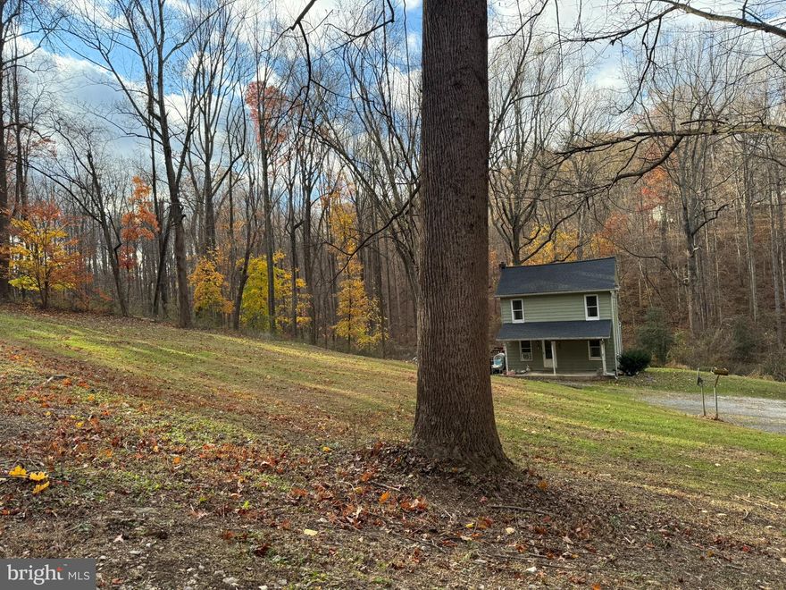 Little green house on the prairie! Adorable two-story home situated on seven + acres.  Imagine living in your own private park like setting and being just five minutes from shopping, restaurants, everything you could imagine!  This house is being sold "AS IS".  Value is in the land.