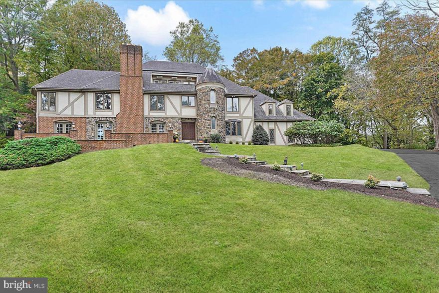 Tapping into Chadds Ford’s bucolic heritage is 2 Chaddwyck Lane, a sprawling very well built stone Tudor mansion, set on a private 5.5 acre estate property in the coveted Unionville Chadds Ford school district.  The understated elegance of the marble foyer spills guests into a sunken living room on the left, perfect for entertaining with wood parquet floors, fireplace #1 and French doors leading to a flagstone outdoor space, or to the formal dining room on the right.  An executive study on the main level offers built in cabinetry and a wet bar with fridge.  Ahead, a sunny family room is further warmed by stone fireplace #2, and plenty of room for family and friends to sprawl.  A well equipped eat-in kitchen offers stone counters, stainless appliances, and a scenic view.  Upstairs, the expansive primary en-suite offers multiple seating areas, fireplace #3, ample closets, sauna and spa.  Four additional bedrooms with jack-and-jill baths finish this level, and the walk up third level has built-in bookcases making it a perfect library, second office or homework space.  Climate controlled attic space is also accessible on this level.  An attached, oversized 3-bay garage is topped with an au-pair suite and well-appointed second kitchen.  The finished lower level adds miles of additional space for billiards, fitness, and more, enhanced with fireplace #4, a full wet bar, and full bath, perfectly suited to entertain guests with the in-ground pool just steps away.  Outside, nestled on the gentle hillside overlooking the Brandywine, the abundance of green space is enveloped in privacy by native trees, and tiers of patios and pathways offering seating and alfresco dining options.  Minutes from fine dining, cultural attractions, vibrant towns and quickly accessible to major routes.  Below market value opportunity to allow for Buyer updates.