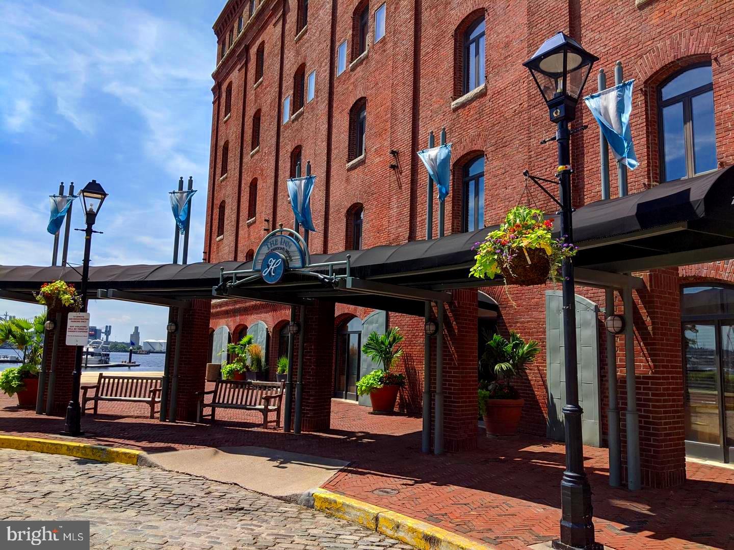 Welcome to luxurious waterfront living in historic Fells Point. This beautifully appointed STUDIO APARTMENT maximizes space with an open, airy layout, offering exposed brick walls, exquisite custom-built in shelving, and Murphy Bed that seamlessly integrate into the architecture, offering both elegance, functionality, and a seamless flow. Located in The Residences and Inn at Henderson's Wharf, you'll enjoy world-class amenities including front desk service, a state of the art fitness center, and a business center. Secure garage parking adds convenience, while the vibrant surroundings of Fells Point are at your doorstep. Experience the perfect blend of elegance and efficiency in one of Baltimore's most sought-after waterfront locations.