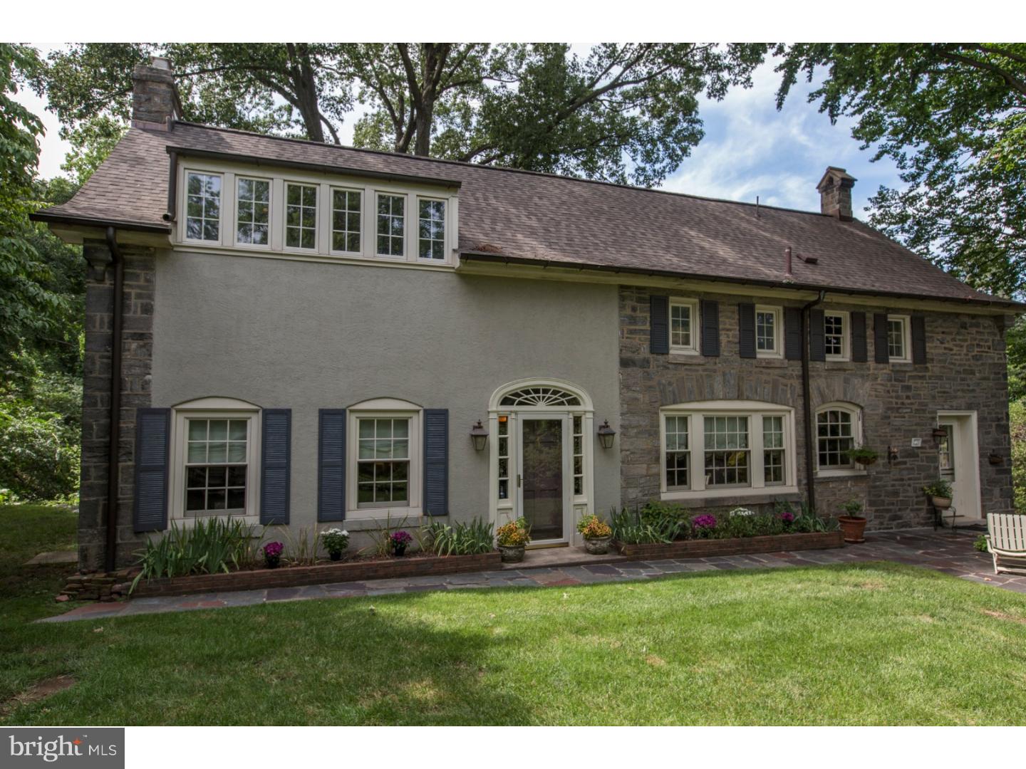 Simply beautiful, unique and filled with light best describes this property, a carriage house once part of  A. Pardee Jr.'s estate.  The house sits above a beautiful winding lane in Olde Wyncote, in a private bucolic setting with lovely space for outdoor entertaining.  Enter into the grand spacious center hall and you will immediately be enchanted.  The elegant fireside formal living room is gracious in size, with hardwood flooring and french doors leading out to the rear of the house.  A handsome step-down formal dining room with high beamed ceilings and a wall of windows with cabinets beneath provides serving area & storage.  The modern kitchen has stainless steel appliances, outside exit with dutch door, and space for an eat-in area.  From the kitchen you can access the 3 car heated garage where you will find the laundry and utilities.  Completing the main level is a 3rd bedroom or family room with a full bath also accessed from the hall.  The second floor includes an amazing dramatic master bedroom suite with exposed stone walls, high beamed ceilings, sitting area, full bath with shower & tub, and a walk-In closet.  A second  bedroom with exposed stone walls & beamed ceiling has direct access to the full hall bath.  Completing the second floor is a cozy den.  Improvements include:  new roof(2012), new Pella windows on the main level, two zoned heating, central air, an abundance of closet space, & exposed hardwood flooring on the main level.  This home has all of the modern conveniences packaged in an incredible stone 125+ year old structure, and is waiting for a discriminating buyer looking for a very special property!!  A One Year Home Warranty is Included.