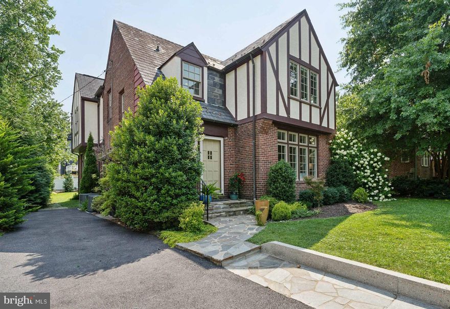 HOT PROPERTY ALERT!!! JUST LISTED  in Historic Stoneleigh is this ultra charming 1930's Tudor style home boasting a well-designed 2 story addition (2005) ! This stunning residence is oozing with character and quality craftsmanship throughout, and seamlessly blends with all the modern amenities you desire! The main level features a welcoming foyer, a serene formal living room with a wood burning fireplace and a wall of windows bringing in tons of natural light, a formal dining room complete with built-ins, a stellar spacious kitchen with huge island  featuring seating for 4 , and the star of the main level is the spectacular family room off the kitchen --- the perfect gathering spot for family and friends!  The upper level also has the ideal floorplan/space you need, with an incredible primary suite plus 3 good sized bedrooms and an updated hall bath with tub/shower combination. TONS OF CLOSETS! TONS OF NATURAL LIGHT! The photos really speak for themselves! The lower level provides additional finished living space, plus a nice powder room.  The outdoor space here is equally impressive and features a lovely covered porch accessed from the formal living room  or the family room - super private and offers the opportunity to screen or finish for additional living space, a rear patio , storage shed, plenty of level grassy area and lush landscaping! Other notable features include the gleaming hardwood floors, Pella windows, high R-value insulation added to attic,  Columbia boiler (2017) , waterproofed basement, 2 zone CAC only few yrs old, and upgraded 200 amp electrical service.  This is truly an ideal home in an arguably IDEAL neighborhood! The Stoneleigh lifestyle awaits!!