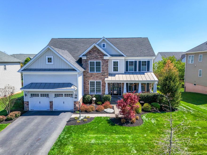 **Open 4/18 1:00-3:00 and 4/19 12:00-3:00**More photos coming soon. Situated in one of the youngest yet well established sections of Dominion Valley Country Club, this exquisite residence offers a harmonious blend of luxury and comfort, perfect for those seeking an elevated lifestyle. Built in 2018, this home boasts 4 spacious bedrooms and 4.5 elegantly appointed bathrooms, encompassing 5702 square feet of smart design and elegant spaces. The thoughtfully designed interior that radiates warmth and sophistication. The open floor plan seamlessly connects the gourmet kitchen, featuring a large island, and high-end appliances, to the inviting family room adorned with a cozy gas fireplace. Elegant crown moldings and chair railings enhance the formal dining area, while the breakfast nook provides a sunlit spot for casual meals. Luxurious flooring options, including hardwood and ceramic tile, flow throughout, creating a cohesive and stylish ambiance. Retreat to the primary suite, where tranquility reigns. This private oasis features a spa-like bathroom with a soaking tub, walk-in shower, and dual vanities, complemented by a spacious walk-in closet. Additional bedrooms are generously sized, with access to beautifully designed Jack and Jill bathroom and one bathroom with private bathroom en suite. Lower level offers plenty of entertaining options for enjoying time with friends and family. Ample unfinished storage can be converted to more finished spaces. The exterior of the home is equally impressive, showcasing extensive flagstone covered front porch, in ground irrigation system and lush landscaping that enhances the property's curb appeal. Enjoy outdoor living in the heated screened porch or entertaining on the expansive deck or simply unwind in the hot tub. The usable flat driveway leads to extended two car garage equipped with installed EV charger, garage hoist, and extra built in storage solutions. The private backyard, bordered by trees, offers a serene escape, while the community amenities-including pools, tennis courts, and a golf course-provide endless opportunities for recreation and relaxation. Conveniently located in a suburban setting, this home is just minutes from commuter lots, an airport, and public transportation, ensuring easy access to the surrounding area. The community itself is gated, providing an added layer of security and peace of mind, close by shopping complex and schools. With its luxurious features, prime location, and exclusive lifestyle offerings, this property is a true gem in Dominion Valley Country Club. Experience the perfect blend of elegance and comfort, where every detail has been meticulously crafted to create a place you will be proud to call home.