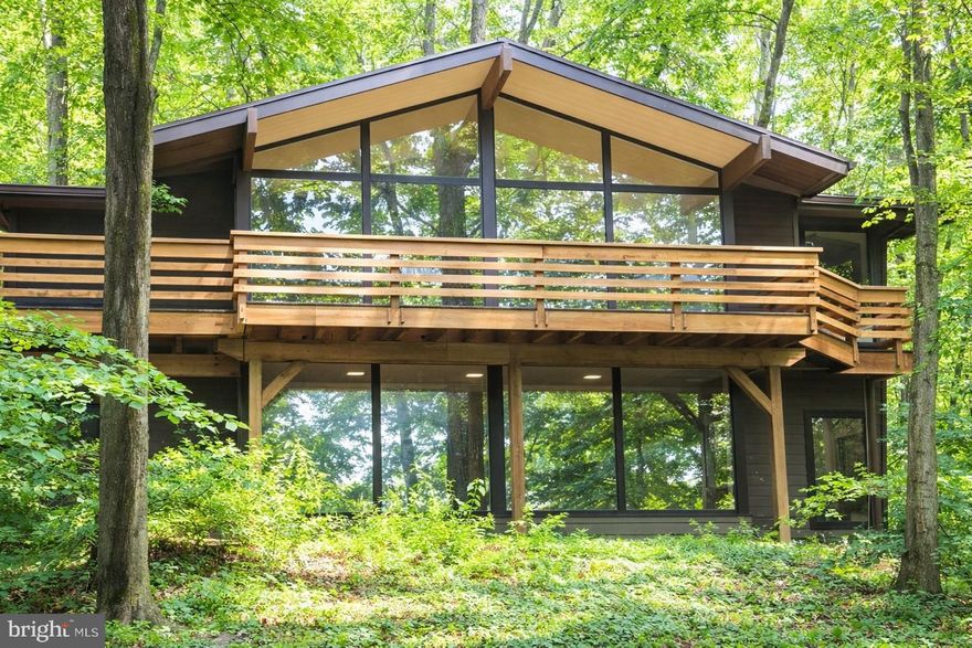 This home will nourish your soul! It has been the privilege of our lives to live in this 2.3-acre McElroy in the T/E school district. Located minutes from VF Park, KOP, and access to major highways, yet nestled in the trees on Valley Forge Mountain, this home offers the best of both worlds. Every day is like being on a vacation, enjoying nature through floor-to-ceiling windows or spending time relaxing by the waterfall by the 30,000-gallon koi pond (which can be converted back to a heated swimming pool if preferred). Or join the VFM swim/racket club, a five-minute walk on the Horseshoe Trail. (With some work, the former tennis court above the pool could be restored or turned into a pickleball court.)

This secluded home has 4 bedrooms, 3.5 baths, a full-house generator, new septic, central air, a gas hot water heater, public water, and PECO natural gas, a 1.5-car garage, Hardie Board siding, and a wired home security system with smoke detection.

The main floor has hardwood floors, exposed beams, and vaulted ceilings throughout, an eat-in kitchen with a 10-foot seamless granite island, DCS 5-burner gas stove, Bosch refrigerator, dishwasher, and convection microwave, as well as a separate pantry, 4 skylights, under-cabinet lighting, and a heated floor, making the heart of this home a joy to be in. The large great room with a gas fireplace and dining room combo makes this a lovely space for family gatherings. 

The very large primary bedroom with a ceiling fan and Jack and Jill vanities boasts more beautiful nature views. Also on the upper floor is a bonus room/office with wrap-around windows, a hallway coat closet, and a powder room with a floating granite countertop and a stone vessel sink. Throughout the upper floor is access to a full-length deck accessed through Anderson doors. The entire floor showcases floor-to-ceiling windows throughout to make the inside feel as one with nature.

Going down the flight of stairs, you enter a large den with floor-to-ceiling wrap-around windows and a wood-burning fireplace. 3 bedrooms and 1 full bath come off the den. The rest of the lower level consists of utility closets, a laundry room with a washer/dryer, and multiple storage areas. The garage enters the house through the laundry room. The garage includes a full bath, which can serve as a mud room.

The grounds behind the house are amazing with slate walkways, a giant koi pond, 10’ tall waterfall sloping up to a former tennis court, and a slate patio perfect for a fire pit.. Surrounding the entire rear property is an aluminum, chain link, and deer fence with a gate exiting onto the Horseshoe Trail. Also in the backyard is a separate “Florida room” with new Anderson windows and doors, so you can sit and feel outside any time of year.

 Ample parking, a recently paved driveway lined with lamp posts, and uplighting will make you proud to arrive home. This beautiful home is move-in ready with fresh paint, new carpet, and a new septic system.