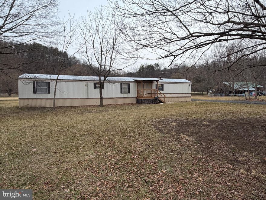 SINGLE WIDE HOME ON 0.47 +/- ACRES! Welcome to 12807 Mason Road.  This 3 bed, 2 bath single wide trailer sits on a level half acre lot across the street from Evitts Creek. The trailer features a living room, kitchen, a primary bedroom with an attached full bathroom, two additional bedrooms and a second full bathroom. Outside, there is a metal shed and a small front porch. Right across the street from 1812 Brewery and minutes from I-68 and Route 220. Needs to be a CASH SALE.