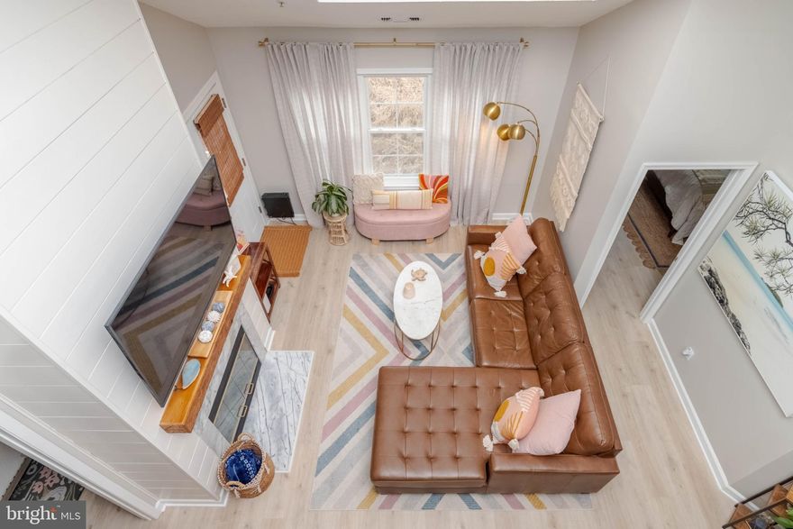 Welcome to this stunning, sun-drenched two-level condo offering 2 bedrooms, 2 updated baths, and a spacious true second floor loft  with 9Ft ceilings ideal for a den ideal/home office or guest space. The home features updated flooring throughout, a beautifully renovated kitchen, and stylish lighting upgrades that elevate the entire space. The open floor plan allows for entertaining or just relaxing in front of the two story fireplace.   Step outside to your private balcony and enjoy the perfect blend of comfort and modern design. Balcony has access from primary and family room.  Brand new HVAC System 2025 and entire unit has fresh paint in neutral colors, so many updates in the beautiful penthouse. Walking distance to shops and eateries, this home and community has so much to offer.