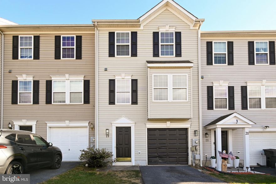 Experience the epitome of modern townhome living just beyond the borders of Martinsburg's city limits. This 3-bedroom, 3.5-bathroom residence offers a blend of comfort and convenience across its three spacious levels. On the lower level, you'll discover a one-car garage, a versatile finished room, ideally suited for a home office or den, and a full bath. Step through the walkout to the backyard. The main level features an inviting eat-in kitchen and dining area that seamlessly transitions to the deck, and a generously sized living room and a convenient half bath. Ascend to the upper level to find the private primary suite, complete with a full bath with separate tub and shower and a generously proportioned walk-in closet. Two additional bedrooms and another full bath provide ample space for family members or guests.