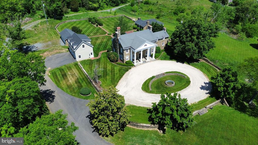 An incredible opportunity to own Historic Roxbury Hall in Leesburg, Virginia.   Welcome to Roxbury Hall — a beautifully restored 100-year-old historic stone manor blending timeless character with thoughtful modern updates. Rich in charm and craftsmanship, the home showcases wood flooring, soaring ceilings, extensive moldings, abundant natural light, and carefully preserved architectural details throughout, with a fully-separate stone guest cottage fully renovated in 2022, including a new kitchen, porch, roof and windows, plus a newly built 3-car detached garage with upper level loft in 2022 and an additional stone workshop.  

Set on over 6 scenic acres at the base of the Catoctin Mountains, this inviting property offers a rare combination of privacy, usable outdoor space, and close proximity to downtown Leesburg, just 10 minutes away. The main residence features 5 bedrooms and 2.5 bathrooms with spacious, light-filled living areas designed for both everyday living and entertaining.

Complementing the main home is a newly built detached 3-car garage (2022) with unfinished upper-level space offering future expansion potential for a studio, office, or guest accommodations. The landscaped backyard creates an ideal setting for gatherings and outdoor enjoyment, framed by mature greenery and multiple functional outbuildings.

A separate stone guest cottage, fully renovated in 2022, sits opposite the workshop and offers exceptional flexibility for guests, extended family, or potential VRBO or AirBnB rental use. Renovations include a new roof, wraparound covered porch, updated flooring, windows, stainless steel appliances, and extensive interior improvements. This cottage is set up perfectly for an AirBnB, generating significant income just 10 minutes from historic Leesburg and in the heart of Loudoun County's winery and brewery scene!

Roxbury Hall presents a unique opportunity to own a thoughtfully updated historic property in one of Loudoun County’s  most sought-after locations!