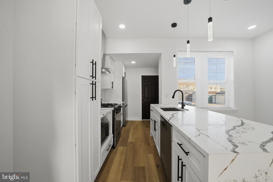 Welcome to 1829 E. Airdrie Street, a beautifully fully remodeled home located in the Frankford section of Lower NE Philly,  a neighborhood known for its transportation access, local shopping corridors, parks, and revitalizing residential blocks. This home features a brand-new island kitchen complete with stainless steel appliances, including a refrigerator and dishwasher, granite-style countertops, modern cabinetry, and all recessed lighting for a bright, contemporary feel. The straight-through layout includes a comfortable living area and dining space, creating an inviting flow throughout the first floor. The upper level offers three bedrooms and a modern hallway bathroom featuring an LED vanity mirror, floating sink, and a glass-doored tub/shower combination. The large storage basement provides exceptional versatility, complete with gas utilities, laundry hookups, and plenty of space to expand or customize in the future. Residents love this location for its convenient access to many Frankford favorites, including: