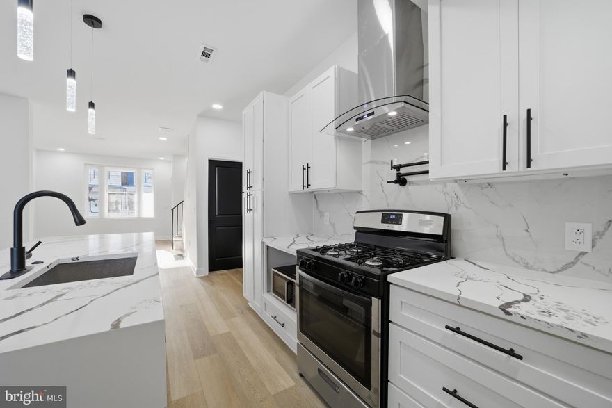 Welcome to 1829 E. Airdrie Street, a beautifully fully remodeled home located in the Frankford section of Lower NE Philly,  a neighborhood known for its transportation access, local shopping corridors, parks, and revitalizing residential blocks. This home features a brand-new island kitchen complete with stainless steel appliances, including a refrigerator and dishwasher, granite-style countertops, modern cabinetry, and all recessed lighting for a bright, contemporary feel. The straight-through layout includes a comfortable living area and dining space, creating an inviting flow throughout the first floor. The upper level offers three bedrooms and a modern hallway bathroom featuring an LED vanity mirror, floating sink, and a glass-doored tub/shower combination. The large storage basement provides exceptional versatility, complete with gas utilities, laundry hookups, and plenty of space to expand or customize in the future. Residents love this location for its convenient access to many Frankford favorites, including: