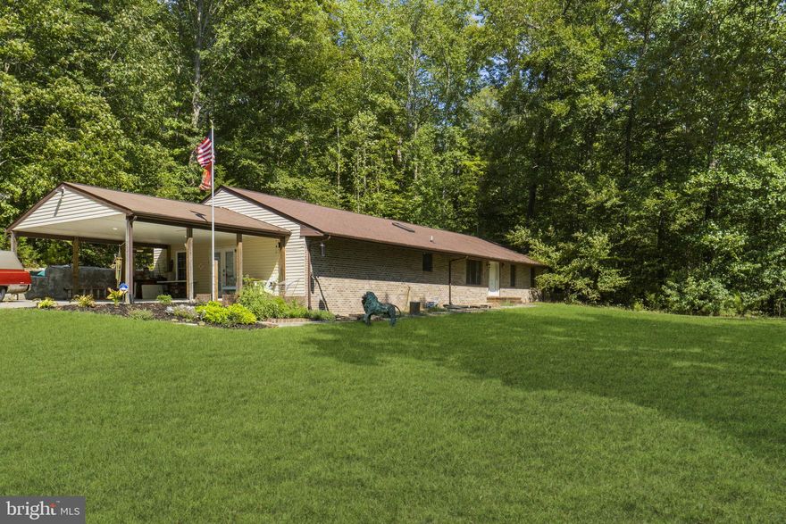 **PRICED REDUCED** MOTIVATED SELLER.  I have been selling homes in Caroline Pines for over 20 years and can tell you without a doubt, this is the best property in the neighborhood!  Unbelievable waterfront at this price.  It is now for sale!  Almost 2.5 acres of cleared flat waterfront property with 430 ft of water frontage.  This home boasts 3 bedrooms, 2 baths, 1800 square feet with a converted garage into additional living space for (288 s.f) possible 4th bedroom  or craft room/hobby cave, and additional workshop and an 8x12 pantry.  Kitchen has been recently renovated with gorgeous white quartz countertops, top end stainless steel appliances, tile backsplash, floors are a beautiful floating laminate throughout the home.  Kitchen appliances include a gas stove/range combo AND a wall oven with microwave. If you love to bake, you have two ovens!  Both bathrooms have walk-in showers; master bath has walk-in shower/tub unit.  Spacious bedrooms with a deep walk-in closet in the primary bedroom.  Nice Rinnai RL75 tankless water heater!  Never run out of hot water!! New electric panel 2020, newer HVAC in 2019 and roof in 2011.  Do not miss this gem!!