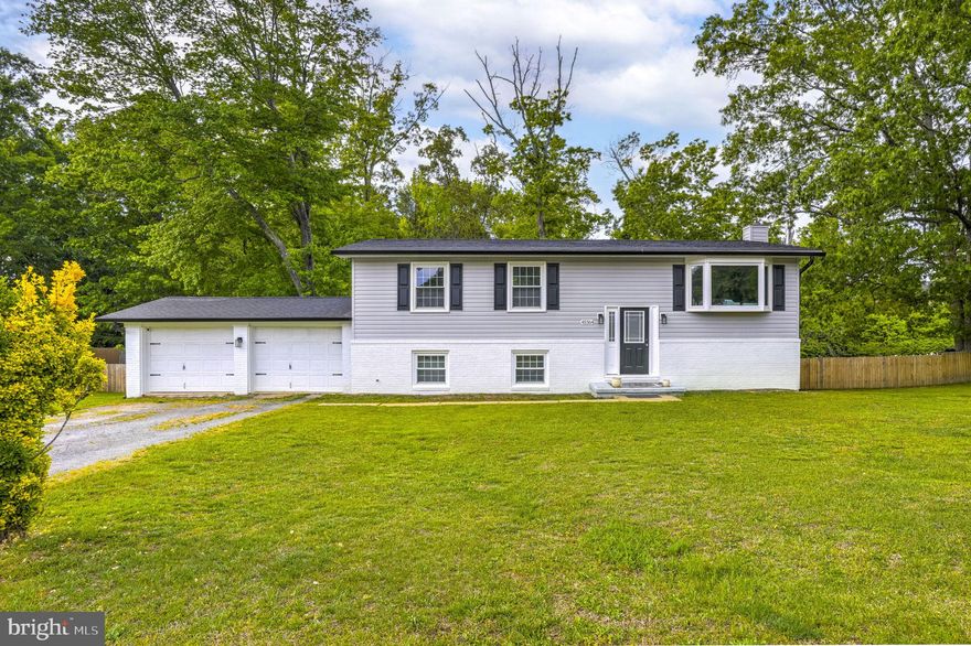 Beautiful 4-bedroom, 2-bath split foyer set on nearly half an acre with a flat yard and a 2-car carriage-style garage. This move-in ready home features a newer roof, windows, siding, HVAC system, appliances, and fully updated bathrooms, offering peace of mind for years to come. Inside, enjoy a bright open layout with luxury vinyl plank flooring, a stylish kitchen with white shaker cabinets, granite countertops, and stainless steel appliances, plus spacious living and dining areas with access to a future deck. The lower level offers a large rec room with a pellet stove, a generous fourth bedroom, full bath, and dedicated laundry room. With ample parking, modern finishes, and thoughtful upgrades throughout, this home delivers comfort, style, and value in one exceptional package.