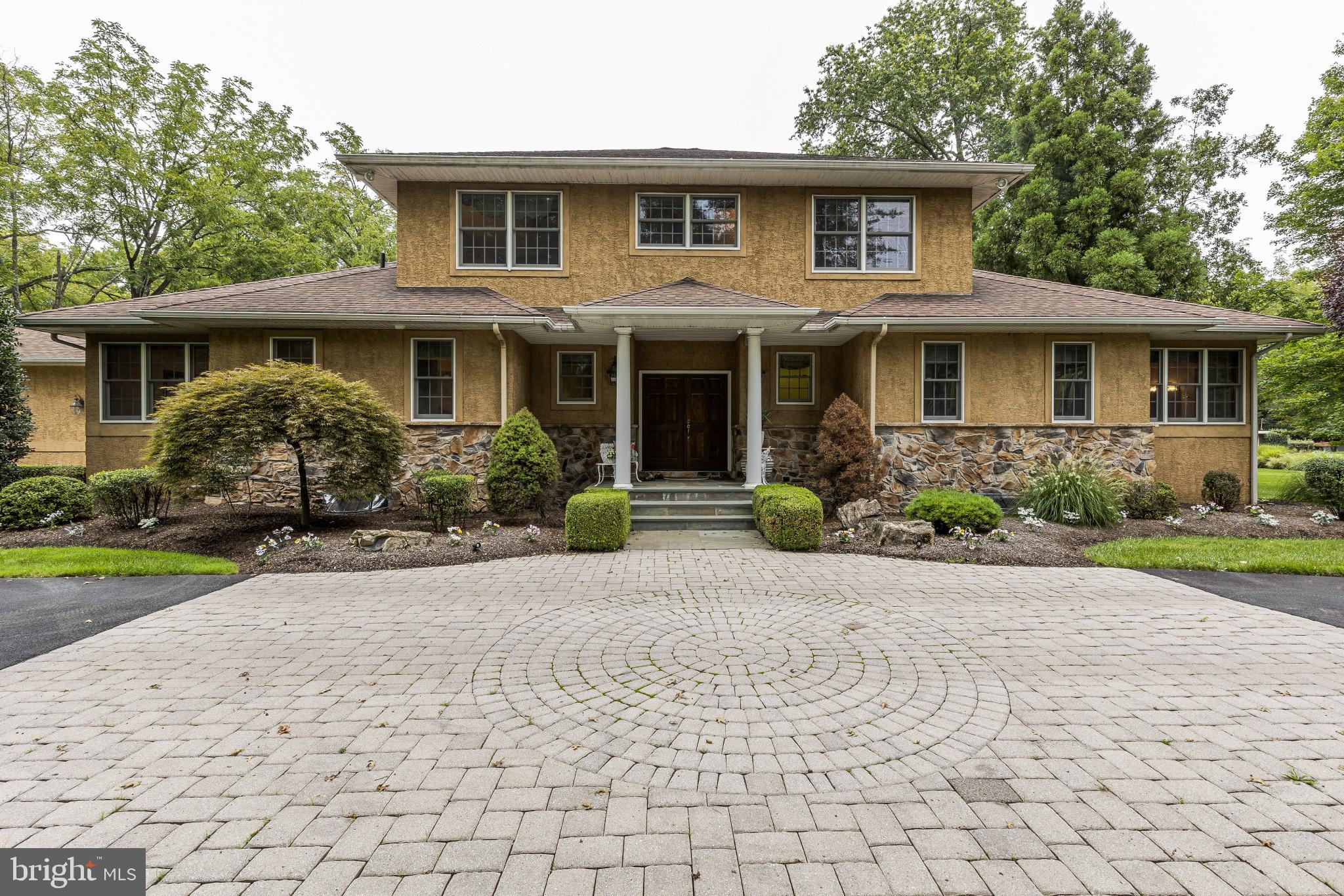 Once in a while, there is a home that is built from the ground up with care and thought and vision.  Welcome to 723 Tennis Avenue in beautiful Lower Gwynedd Township!  This custom- built home has done just that!  A private lane and circular courtyard  leads you to the meticulously cared for property.  Over 2 acres of lush green land, woods and pastures surround you on this marvelous estate.  The home consists of 5 bedrooms, two of them en-suite and on the first floor, and three and a half baths.  The main floor is home to an enormous family room with a fireplace (wood burning and gas) with a floor to ceiling sone façade.  Off of the family room to your left you will find glass French doors that lead to the formal dining area with seating for more than 12 and easy access to the chef’s kitchen.  This eat-in kitchen has a six-burner gas stove, plenty of counter and cabinet space, large island with seating, two ovens and two dishwashers to make cooking and clean up a snap.  Off of the kitchen is a huge mud room with super-sized pantry, coat closet, third bedroom and access to your oversized 3-car garage, no need for bike racks in here! Back thru the spacious family room to the study/library with custom shelving (which looks built in!) this area could be used as a home office, or extended entertaining space, with a very similar feel to a parlor, so common to historic homes.   The natural light on the first floor makes this grand area feel very open and light.  Views of a historic farm house with pastures and beautiful mature trees are seen from every window.  Glass Doors lead you out to the beautiful stone patio with gas grill (gas line direct from the house so you will never run out!) and tons of seating to extend your entertaining outdoors.  There are two en-suite bedrooms on this level.  One, is the master with a dressing room and two gigantic walk-in closets.  The second en-suite bedroom would be a great in law-suite with its own entrance from the outside, or a good playroom or teen hang out.  As if more space was needed, the full walk out basement is dry, with extremely high ceilings (keeping in time with the rest of the house) as well as your very own wine cellar!  Finish off this space or use it for storage galore.  The second floor of this home boasts two very nice sized bedrooms with great closet space and a full bath to share.  All of this in a very private setting and locate din A + Wissahickon School District.  Make your appointment to see this property for yourself.  You will not be disappointed!