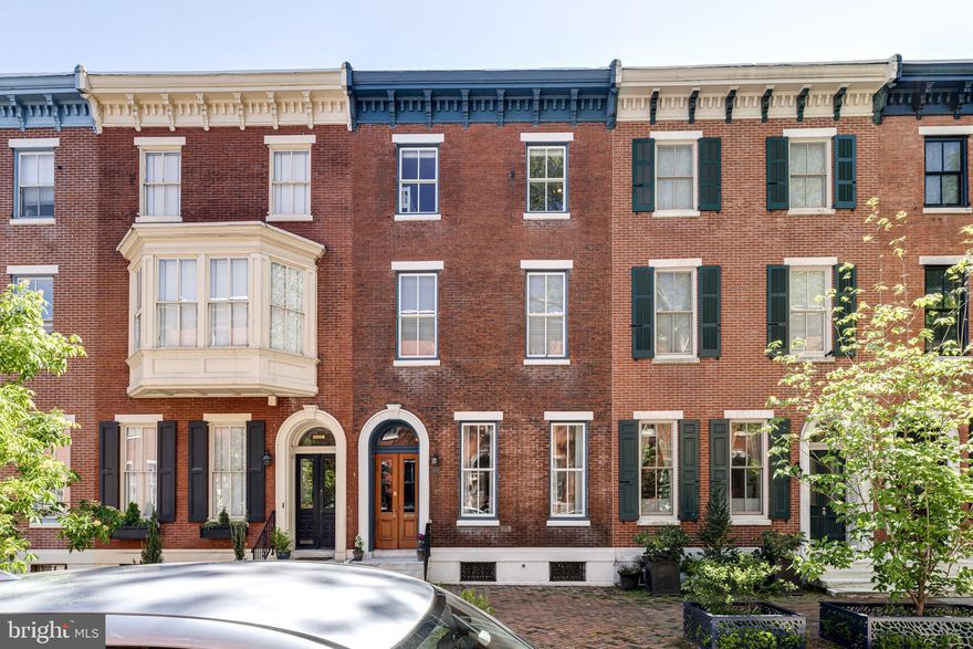 2010 Mount Vernon is a truly exceptional, beautifully updated 20-foot-wide townhome located on one of the prettiest blocks in the Art Museum neighborhood.   Offering 5 bedrooms w/4.5 bathrooms and over 3,900+ sq/ft of renovated living space perfectly blending original architectural details w/modern amenities.   A gracious double door vestibule opens to a formal entry foyer w/access to the large living room while also showcasing a gorgeous original staircase.  Main living room features a marble fireplace w/gas insert, high ceilings, incredible millwork and floor to ceiling gold framed mirror flanked by two large windows and a matching gold and glass chandelier.  Just beyond is the open dining room and kitchen w/lots of windows and a slider to the side deck and sunny rear brick patio.  Spacious kitchen has a large center island w/seating and also features a sweet built-in bench w/seat cushions and storage under the windows.  Smart stainless-steel appliances are set against stone counter tops, backsplash and custom white wood cabinets.  There's also a well-placed powder room w/pocket door on this floor.   Side deck area is large enough for bike and additional outdoor storage and the rear patio is ample size to dine/entertain all summer long.  2nd level features a big family room w/an additional fireplace, custom shelving and built-in desk.  Primary suite is also on this level and has incredible closet spaces on two walls from floor to ceiling and a 4-piece bathroom offering heated floors, enormous walk-in shower and free-standing tub.  There's also another bedroom in the back of the house and full hall bathroom on this floor.  Top level has 2 bedrooms and a full bathroom in the front with an open library/reading area and an additional bedroom and full hall bathroom and laundry room towards the back of the home.  Large custom outfitted closets in all the BR's and great storage in the laundry.  Fully finished lower level has over 450+ sq/ft of flexible space to use for fitness, playroom, home office, and lots of added storage space.   Truly move in condition with amazing attention to detail throughout as well as an energy efficient home w/3 zone heat and HVAC.  Walk to all that this neighborhood has to offer just steps to Whole Foods, Target, Restaurants, Museums, Shops and Kelly Drive.  2 years of prepaid parking in a private lot is also included.