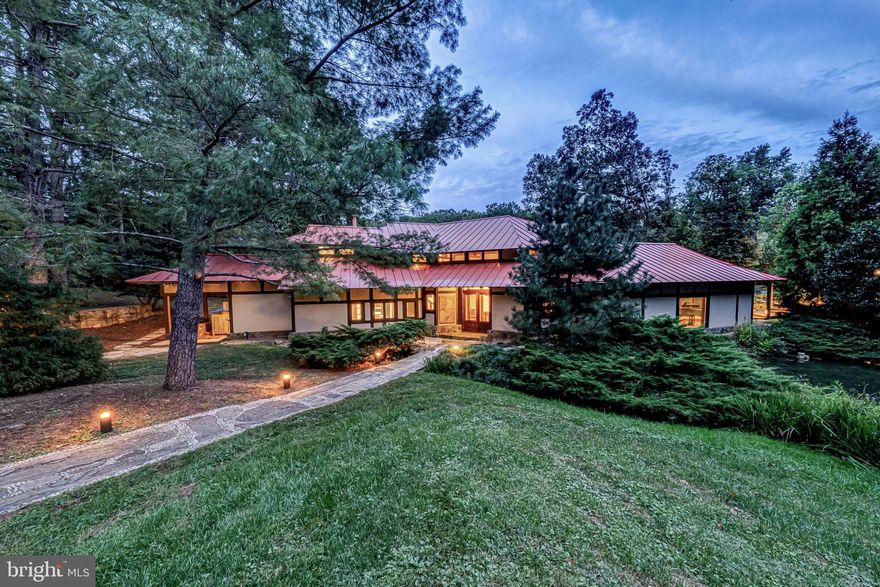 Oak Hollow — A Harmonious Haven of Craftsmanship and Nature

Tucked away in Orange County Hunt territory, minutes from The Plains and I-66, lies Oak Hollow, a breathtaking 30-acre farm that blends refined architecture with the timeless tranquility of nature. This extraordinary property is a masterwork of Craftsman style, deeply influenced by the quiet elegance of Japanese design—drawing inspiration from none other than the revered Katsura Imperial Villa, one of Japan’s most beautiful architectural treasures.

Every inch of Oak Hollow is handcrafted with reverence for natural materials and a philosophy of balance and serenity. Custom designed and built in the mid 1980's, the sprawling main residence is composed of warm, exposed woods and simple, graceful lines that invite nature in at every turn. Large windows frame curated views: to one side, a small koi pond reflects the sky; to the other, a shimmering black bottom pool gives way to a larger pond that stretches toward the tree-line.

As you explore the home and its surroundings, the garden tells a quiet story. Close to the home, the landscape is intimate and detailed, a living tapestry of meticulously arranged plants, water features, and stones. Venture further, and the gardens gradually loosen into open farm fields, blending with the broader rhythm of the land. This transition—from crafted garden to expansive farmland—is seamless, embodying the Japanese ideal of a space at peace with itself.

Paths meander through what feels like an unfinished Japanese walking garden—evocative, poetic, alive in its evolution. Water flows gently through the land, connecting the home to a series of serene, terraced ponds below. The grounds could be an arboretum in their own right, rich with native Virginian species and hidden corners of botanical wonder. The gardens and fields are abundant with plants native to the Virginia Piedmont and Blue Ridge Mountains, filled with enough species to qualify as a Level 1 arboretum. 

As you enter Oak Hollow, the barn greets you to the right—offering seven well-appointed stalls and generous turnout pastures. A simple, grass riding ring sits across the drive.

The main living room is a revelation—anchored by handcrafted built-ins, including butterfly joints inspired by George Nakashima. and oriented toward dual vistas. Throughout the home—living room, dining room, family room, and primary suite—custom woodwork and timeless design elements abound. The main house residence, approximately 3,400 SF,  offers three serene bedrooms and three finely appointed baths. The primary suite is a true retreat, complete with a private office set at the rear of the home, overlooking the layered gardens, pond, and distant forest—a perfect vantage point for inspiration or quiet reflection. 

Connected by a softly lit covered walkway, the guest house, 1,600 SF,  offers yet another space of tranquil refinement. With soaring vaulted ceilings, exposed beams, a full kitchen, spacious living area, primary bedroom, bath, and ample storage, it mirrors the craftsmanship and calm of the main residence—yet feels like its own meditative escape.  

Oak Hollow is more than a home. It is a sanctuary—where architecture, land, and water exist in perfect harmony. It’s a rare and beautiful place, both connected and secluded, just minutes from modern convenience.  SUBDIVISION creating one an additional lot ( 4.5 acres) is allowable.