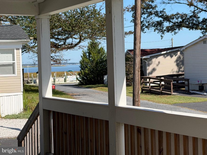 Priced to sell—bring all offers! Enjoy stunning water views and your own beach access from this charming corner-lot home. Located just a short walk to the boat dock, this property features a paved driveway with room for 5 cars, a spacious wrap-around screened porch perfect for relaxing or entertaining, and a newer pitched metal roof for long-lasting durability. The large outdoor shed with electric is ideal for your zero-turn mower, tools, or even a small workshop. Don’t miss this unbeatable location and lifestyle—schedule your showing today!