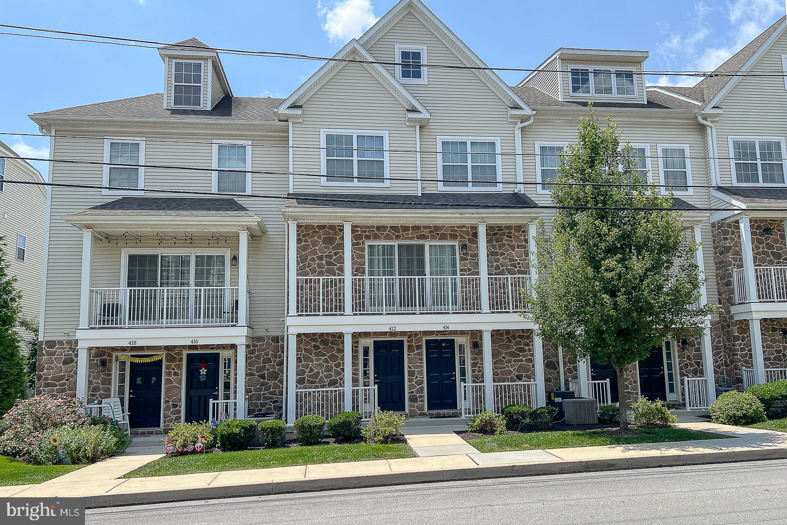 Introducing 412 Danielle Way, a beautiful stone-front townhome in the highly sought-after Union Station II community in the heart of West Chester Borough. This "Glen Millls II - Court View" Model boasts 3 bedrooms, 3.5 bathrooms and builder-upgrade options galore across its 1,900 square feet and four finished levels. Enter on the Ground Level to an inviting laminate-floored foyer with coat closet, inside access to the tandem two-car garage which features the builder-upgrade optional storage closet, and stairwell up to the Main Level. Ascend the stairs to the Main Level to be greeted by open concept living at its finest: a living room with lots of natural light and the adjacent dining area overlooks the covered balcony and is conveniently located right next to the kitchen. The kitchen features stainless steel appliances and sink, garbage disposal, gas range, granite countertops and island, recessed lighting, under cabinet lighting and above cabinet lighting. The aforementioned covered balcony with west-facing views provides a great space to wind down the day and watch the sunset. A cleverly tucked-away half bathroom and closeted, stacked washer/dryer complete the wood-floored Main Level. Head upstairs to the Third Level for the Primary Suite with lighted ceiling fan, crown molding, walk-in closet and gorgeous, brand-new beautifully updated primary bathroom with two sinks and stylish, expansive walk-in shower with tile surround and two separately-controlled shower heads (one doubles as a handheld shower head). Next to the Primary Suite is Bedroom #2 (currently functioning as an office) with great natural light, crown molding, lighted ceiling fan, and a closet, and just down the hall is a full bathroom with combination tub shower to service this second bedroom. Ascend the stairs once more to find the inviting Loft with privacy door, currently functioning as a bedroom. The carpeted Loft features separate heating and cooling and an ensuite full bathroom with combination tub shower. Just two blocks from the hustle & bustle of Market Street and with a fantastic Walk Score of 88, all of the restaurants, cafes and shops are a short walk away; this is West Chester Borough living at its finest, not to forget the award-winning West Chester Schools! Also convenient for commuters with quick access to Route 202, Route 3 and Route 322. Schedule your showing today and make this exquisite townhome yours!