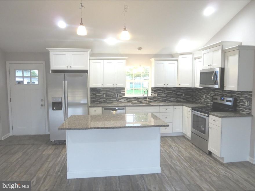 IMPRESSIVE. The only way to begin to describe this home. Another distinguished home completed by F & J Home Improvements that must be seen to be appreciated! On a scale of 1-10 this home is totally off the charts! Expanded remodeled 4BR 2BTH ranch features open floor plan with antique oak hand scraped flooring and vaulted ceilings (fireplace has been removed to create Great Room). One of a kind designer kitchen features white shaker cabinets with 42" accent cabinet w/ glass tile back splash, granite counter top w/ stainless drop in sink w/ pull out faucet and garbage disposal, whirlpool stainless package w/ 36" side by side frig with ice and water in door, glass cook top range, built in dishwasher and microwave, recessed lighting, island counter w/ granite counter top with overhang for extra seating, pendulum lighting and laundry closet off of kitchen w/ ceramic tile floor.  Adjacent living room wit atrium door to rear yard, recessed lights and ceiling fan. Addition where carport once was can be utilized as a dining room or family room and features shadow box/chair rail combination, recessed lights and ceiling fan.Rear addition has been converted to Master Suite and features vaulted ceiling with new w/w carpet, recessed lights, ceiling fan and full bath with custom accent pebbles and soap caddy, ceramic tile walls and floor and large walk in closet with wire racks.Original side of home features 3 bedrooms with w/w carpets and ceiling fans, hall bath w/ tub w ceramic tile walls w/ glass inlay and built-in soap caddy, ceramic tile floors and dual flush toilet. Exterior features new 3 dimensional roof/maintenance free vinyl siding/double hung windows, large partially fenced rear yard, new 4 car macadam driveway, sidewalks and apron.  Extras include all new sheet rock, insulation and electric wiring throughout, Trane XR electric heat pump with central air, RHEAM 50 Gal hot water heater, 200 AMP circuit breaker system,  replaced sewer line and all new plumbing in slab, cable wired, fresh paint and new 2 paneled arch door throughout and pull down attic for storage. Close to major roads and shopping. Available for quick settlement. Won't last, just pull up the moving truck!