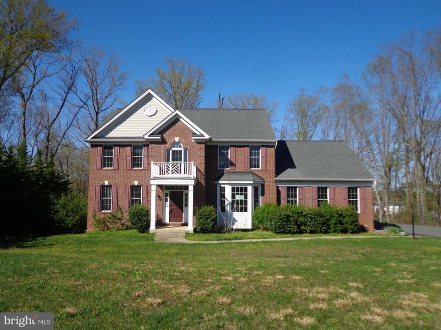 Beautiful Secluded Colonial! This home offers hardwood floors on the main level, formal living room with built in book cases, office off of the cozy living room with a fireplace, dining room, and kitchen with eat in breakfast nook! The basement is partially finished with a theatre room and a large rec room with a full bath! Outside you will enjoy the deck and in its privacy! Home sold "AS-IS."