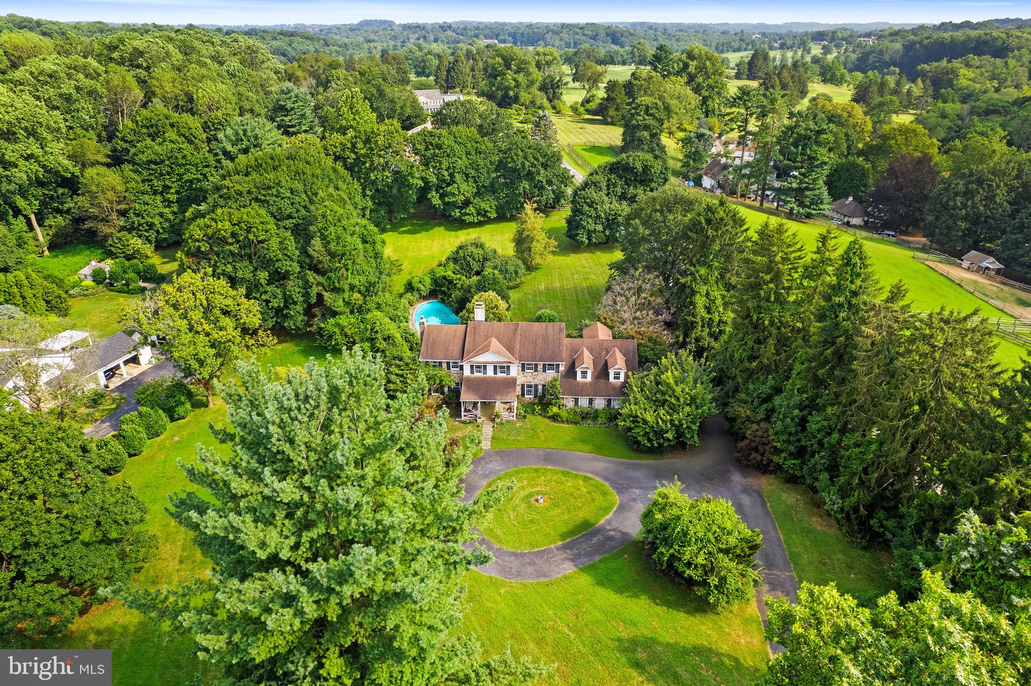 Heavens, not making any more of this rare opportunity to be the next lucky stewards of this iconic Radnor Hunt Jewel. Set on a breathtaking 2.1-acre lot down a long butler loop driveway, this stunning stone residence, oversized spacious two-car garage with carriage doors, custom Sylvan 36,000-gallon pool, and grape-lined fence, offers every ingredient for gracious country living at its best. The original 1967 farmhouse has been thoughtfully custom-built by John McClatchy builders as the personal residence for son James McClatchy’s young family over the years and includes wonderfully open living and entertaining spaces, incorporating the sun-filled interior, large rooms, and private grounds. Endless features include a charming front foyer, a beautiful living room, and a dining room scaled to host large gatherings. The cozy family room features rustic beams, wide-plank floors, and a fieldstone wall with a fireplace that overlooks an expansive lawn, pool, and gardens. The country kitchen opens to a bright breakfast room with a wall oven and an alcove with a built-in grill overlooking pristine horse pastures and paddocks. The second floor primary suite includes a large walk-in dressing room, a full bathroom with his and her sinks, and a spacious bedroom. There are five additional bedrooms with en-suite baths, including a private two-room pair suite and a guest suite off the staircase. Enjoy this priceless, oasis-like setting while being within a short ride on the surrounding riding trails to Radnor Hunt and just minutes from renowned schools, endless golf courses and recreational opportunities, fabulous restaurants, shopping, and all forms of transportation. Owned by the same family for almost twenty-three years, this one-of-a-kind treasure is not to be missed!