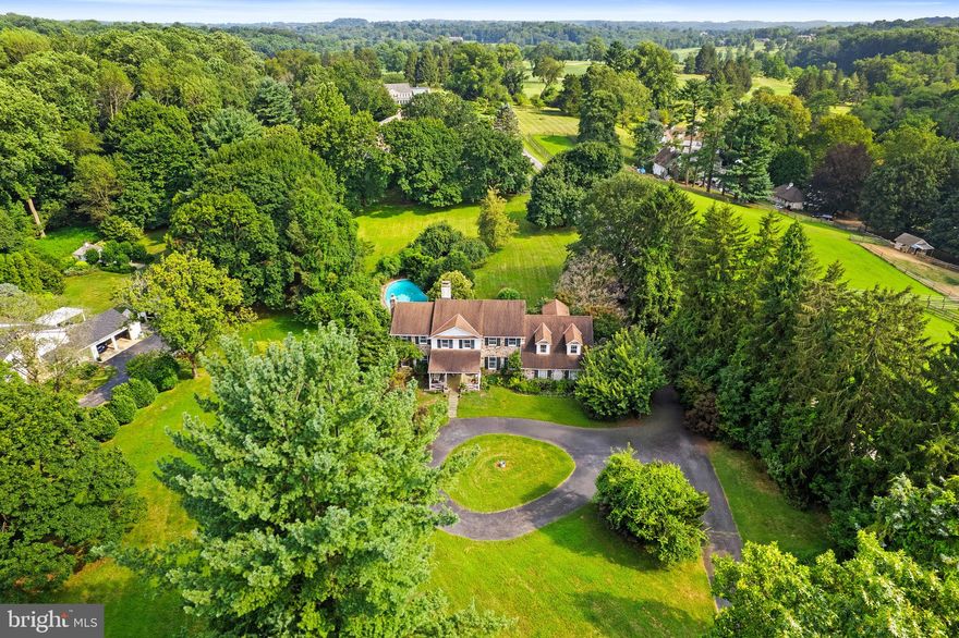 Heavens, not making any more of this rare opportunity to be the next lucky stewards of this iconic Radnor Hunt Jewel. Set on a breathtaking 2.1-acre lot down a long butler loop driveway, this stunning stone residence, oversized spacious two-car garage with carriage doors, custom Sylvan 36,000-gallon pool, and grape-lined fence, offers every ingredient for gracious country living at its best. The original 1967 farmhouse has been thoughtfully custom-built by John McClatchy builders as the personal residence for son James McClatchy’s young family over the years and includes wonderfully open living and entertaining spaces, incorporating the sun-filled interior, large rooms, and private grounds. Endless features include a charming front foyer, a beautiful living room, and a dining room scaled to host large gatherings. The cozy family room features rustic beams, wide-plank floors, and a fieldstone wall with a fireplace that overlooks an expansive lawn, pool, and gardens. The country kitchen opens to a bright breakfast room with a wall oven and an alcove with a built-in grill overlooking pristine horse pastures and paddocks. The second floor primary suite includes a large walk-in dressing room, a full bathroom with his and her sinks, and a spacious bedroom. There are five additional bedrooms with en-suite baths, including a private two-room pair suite and a guest suite off the staircase. Enjoy this priceless, oasis-like setting while being within a short ride on the surrounding riding trails to Radnor Hunt and just minutes from renowned schools, endless golf courses and recreational opportunities, fabulous restaurants, shopping, and all forms of transportation. Owned by the same family for almost twenty-three years, this one-of-a-kind treasure is not to be missed!