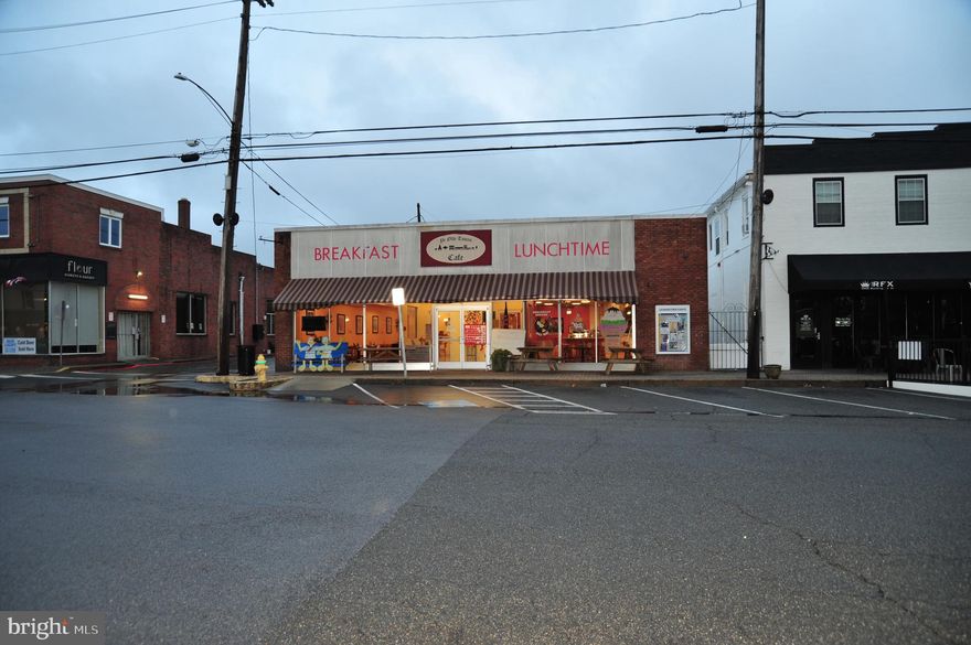 BIG PRICE REDUCTION
Offered for sale is the PCI22685, LLC property known as 22685 Washington Street, Leonardtown, MD 20650, formerly known as Ye Olde Towne Cafe, LLC.    This is a prime business location, on the Square in the heart of historic Leonardtown, a thriving business and cultural activity community.   Current building layout includes approximately 5,278 sq. ft. of retail area that hosts both a large cook line and a separate prep kitchen, a long food service bar, handicap rated bathrooms, and a separate party/meeting room.  Retail area can easily accommodate 90 - 120 patrons.   There is also an approximate 1,518 sq. ft. of additional storage and warehouse area that includes the building mechanical systems and electrical service panels, a walk-in refrigerator and freezer, an office space, and an additional bathroom.  

Outside, a srayed-foam overlay on the roof was installed in March 2025, which includes a 20-year warranty.  The retail area has been upgraded to energy saving LED style lighting, and new HVAC compressors and oil-fired furnaces have been installed within the past 5 years.  The building features a monitored fire and burglar alarm system, and a 16-channel video security system with both indoor and outdoor cameras that can be monitored internally or accessed via the internet.  Although currently configured as a restaurant, the building lends itself to reconfiguration for a variety of other purposes, including general retail or commercial office space.