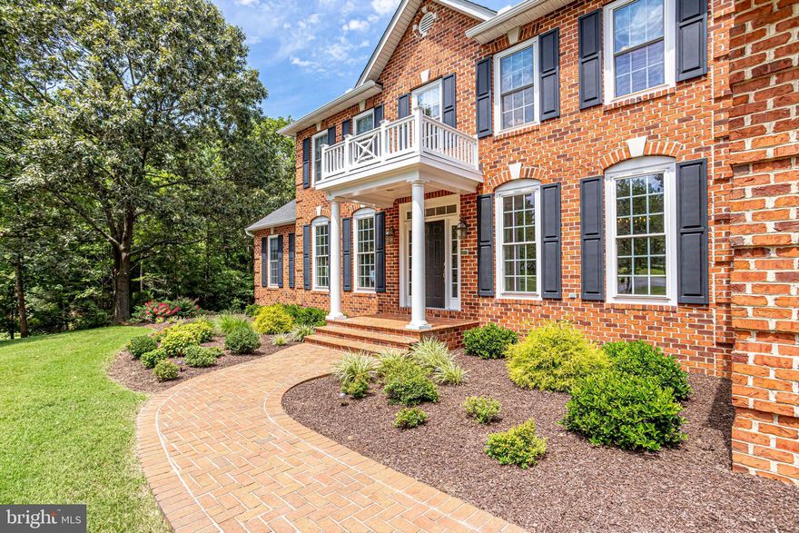Elegant, custom-built colonial tucked away on over 4 private acres. Enter the home from the curved driveway and admire the lovely mature landscaping as you wander down the brick walkway. The home exudes the aura of a gracious, southern plantation from days gone by. The spacious, main level of the home offers a formal dining room, formal living room, guest bedroom, sun room, breakfast room off of the gourmet kitchen which adjoins a 2-story family room with skylights & fireplace. You will love the 3 car garage which opens into a mud/laundry room. The upper level of this home boasts 4 spacious bedrooms and 2.5 baths. The master bedroom has its own fireplace, vaulted ceilings, sitting room, skylights and very generous walk-in closet. Hardwood flows through the main level of the home and the walk-out lower level. A wonderful "man cave"; the lower level has a guest bedroom, full bath, large family room, exercise/office, workshop and ample storage. The rear of the property has a grand deck off of the kitchen and a lovely, shaded brick patio accessed from the lower level. The homes has been impeccably maintained and has many upgrades including a new roof. Home is located in water access community with pier, pool, tennis courts and grand club house.