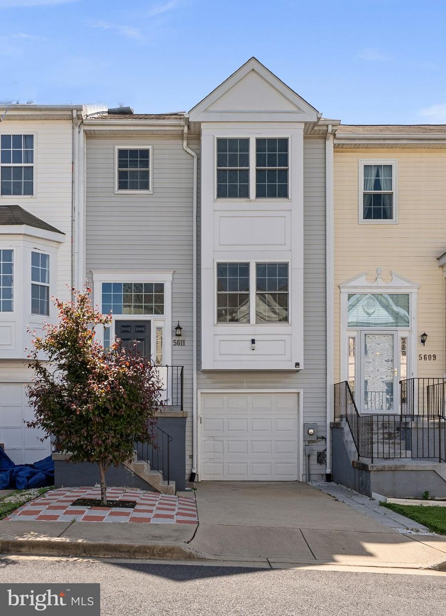 Beautifully updated garage townhome located in the highly sought-after Stonebridge community! This light-filled home welcomes you with an inviting foyer featuring ceramic tile flooring and a wooden staircase leading to the main level.

The main level offers an exceptional open layout, highlighted by a tremendous living room with gleaming hardwood floors, elegant crown molding, and a cozy gas fireplace. Two sliding glass doors flood the space with natural light and provide seamless access to the private deck—perfect for relaxing or entertaining. The formal dining room features hardwood flooring, crown molding, and an updated chandelier, with a convenient pass-through to the kitchen.

The spacious kitchen is thoughtfully designed with ceramic tile flooring, white cabinetry including a pantry, granite countertops, and a stylish tile backsplash. Stainless steel appliances include a new microwave, updated double gas oven, dishwasher, and refrigerator, along with an undermount double stainless steel sink and a large window for abundant natural light.

A convenient powder room on the main level features ceramic tile flooring and an updated vanity with modern bowl sink, mirror, and lighting.

Upstairs, hardwood flooring continues throughout the hallway and all bedrooms. The impressive primary suite features vaulted ceilings, a ceiling fan, a large picture window, a striking brick-style accent wall, and a generously sized closet with custom organizers. The en-suite bath includes ceramic tile flooring, a separate shower and bathtub, and an updated vanity with granite countertop, along with updated lighting and mirror.

Two additional spacious bedrooms offer ceiling fans, large windows with blinds, and closets with organizers. A full hall bath with ceramic tile flooring, tub/shower combination, and updated vanity completes the upper level, along with a convenient linen closet.

The finished walk-out lower level adds valuable living space and includes a laundry closet with LG front-load washer and dryer, a sliding glass door to a lower deck, and a powder room with ceramic tile flooring and a single vanity with granite. Additional features include under-stair storage, a one-car garage with updated garage door opener, Nest thermostat, alarm system, and a reconditioned deck and staircase overlooking  a charming backyard with a mature tree providing shade and a picturesque setting.
This home combines style, comfort, and functionality in a prime location—don’t miss this incredible opportunity!