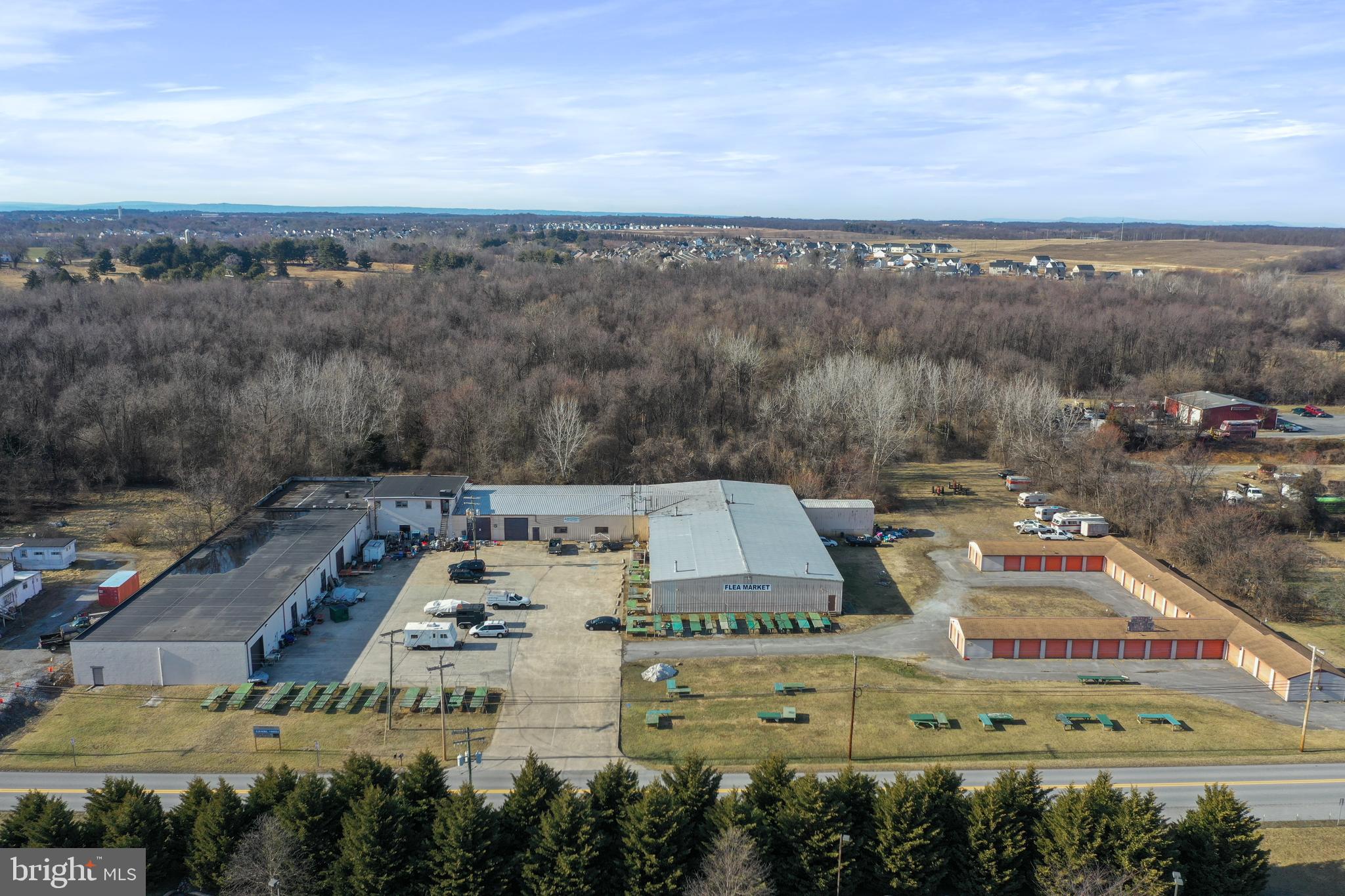 Welcome to 197 & 243 Halltown Road, Harpers Ferry, WV—a rare, multi-parcel commercial opportunity located just off Route 340 near Charles Town, WV. This expansive offering boasts nearly 40,000 square feet of versatile warehouse space, thoughtfully configured into various sizes to accommodate a range of business needs. Adding immediate revenue potential are 81 self-storage units, an in-demand asset in this growing region.
The property sits on three separate parcels, totaling 13.29(+/-) acres of contiguous commercial-zoned acreage. A vacant 10-acre parcel is ideal for expansion of the existing facility or the development of entirely new projects. This valuable zoning flexibility empowers owners to add more storage, warehouse, or light-industrial structures, or consider other lucrative commercial ventures.
Though carrying a Harpers Ferry address, this site is mere minutes from Charles Town, WV, ensuring convenient access to major thoroughfares and a steady flow of local and regional traffic along Route 340. Whether you envision a regional distribution hub, a thriving self-storage complex, or a multi-use commercial campus, this prime location makes it all possible.
Key Highlights:
· Nearly 40,000 sq. ft. of warehouse space configured in various sizes
· 81 self-storage units providing immediate income
· 10 acres of commercial-zoned land for future development
· Strategically located along Route 340 near Charles Town, WV
· Three separate parcels, offering flexibility in usage or resale
This property combines an existing, income-generating operation with additional value of the land for future development potential. Strategically located in a growing area and zoning that allows for a wide range of commercial activities, this is your chance to secure a cornerstone asset in a prime location.