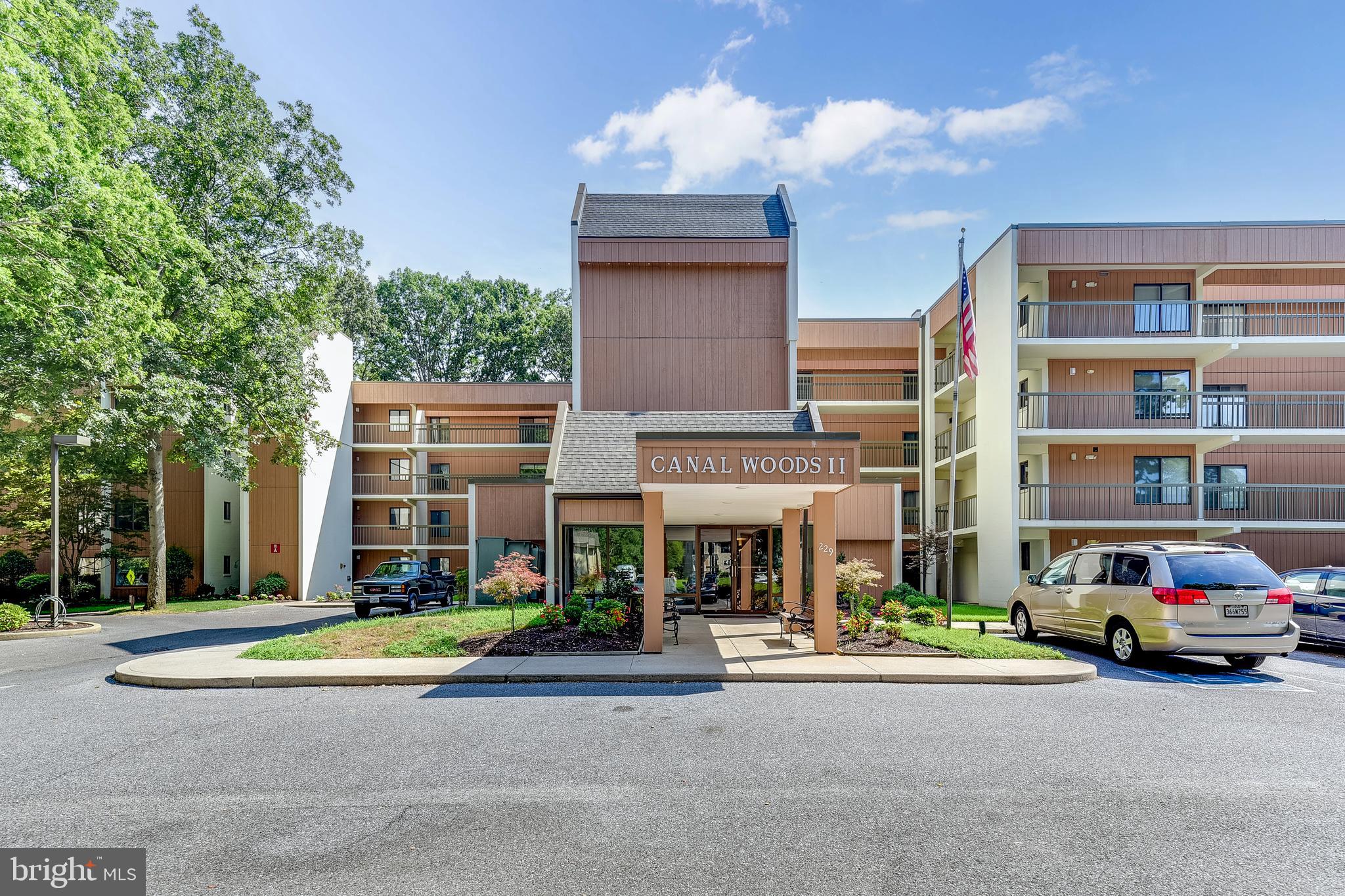 Welcome to this beautifully appointed 3-bedroom, 2-bathroom condo in the sought-after Canal Woods community. Located on the third floor of the Canal Woods II building, this end-unit residence offers an abundance of natural light and stunning views of the tranquil Tony Tank Pond, making it the perfect retreat for peaceful living. Upon entering, you’ll be greeted by an open and airy floor plan with spacious living areas. The large living room flows effortlessly into the dining area, ideal for both relaxed evenings and entertaining guests. Step outside to your private balcony and enjoy picturesque views of the pond—an ideal spot for morning coffee or watching the sunset. The kitchen is well-equipped with ample cabinetry and counter space, perfect for preparing meals while taking in the surrounding natural beauty. The primary bedroom offers a generous space for relaxation and has an en suite bathroom that features a walk in closet, linen closet, dual sinks, and ample storage space . A second well-sized bedroom provides flexibility for guests or family, while the third bedroom has been thoughtfully transformed into a versatile den, providing the perfect space for a home office, library, or media room. Additional features include in-unit laundry, plentiful closet storage-including an additional storage unit that is utilized directly off the elevator, and easy access to community amenities, including walking paths, bike trails, and the peaceful surroundings of Tony Tank Pond. The building is well-maintained, and residents enjoy the convenience of ample parking. Perfectly located with a short drive to downtown, the beach, and local dining, this condo offers the best of both convenience and serenity. Don’t miss your chance to own this beautiful, third-floor condo with scenic pond views in Canal Woods!