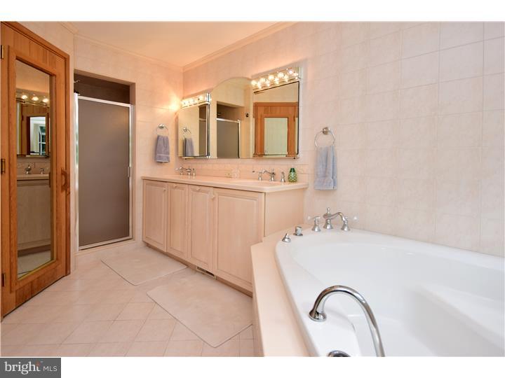 Tall verdant pines, rhododendrons and lush green vistas ?.that's what you'll see through the windows of this Wonderful Swarthmore Hills Home! Secluded from the street, the Covered Front Porch takes you to an elegant tiled floor Foyer. It's impossible not to go straight to the huge bay window in the Living Room that overlooks a tranquil yard, totally walled in for pets or play. The renovated  Kitchen has a European flair, with new counters, appliances, bamboo flooring  and a bright and sunny Breakfast Room lit by two large skylights. The Elegant Dining Room is directly off the Kitchen and opens to the Living Room with wood burning fireplace, giving the entire first floor a perfect flow for entertaining.        And then there's the First Floor Master/In-Law Suite: a Huge Bedroom with new carpeting and a gorgeous Bathroom with sauna yes, SAUNA, tub, shower, double bowl sinks and tiled flooring. The Family Room with built-in bookcases and Hall Bath complete the Suite.     The Second Floor Features Four generously sized Bedrooms (one currently being used as an office) and an updated Hall Bath.     There's storage space galore in every part of this house with tons of closets and a huge Attic.       Lovely Landscaped Yard surround, giving beautiful views from every window in the home. Enjoy relaxing with your morning coffee or entertaining Friends and Family on the Large Patio, which can be accessed from the Breakfast Room, Dining Room and Living Room, creating an amazing and unique flow of indoor/outdoor living as you overlook a sea of private green that will make you forget there are neighbors surrounding. All of this on a quiet winding street in one of Swarthmore's loveliest neighborhoods and just minutes to shops, train and SRS Elementary School.