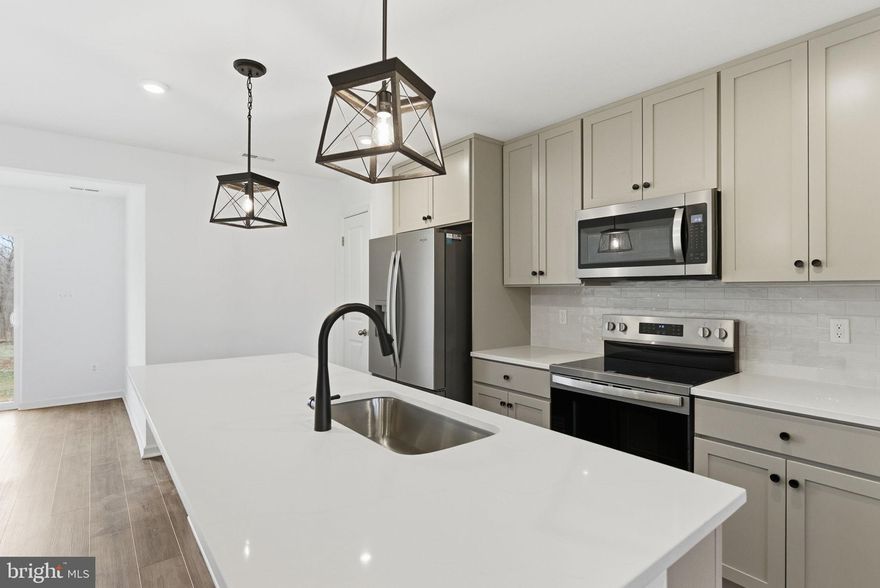 *OFFERING UP TO $12,500 IN CLOSING  COST ASSISTANCE FOR PRIMARY RESIDENCE WITH USE OF APPROVED LENDER AND TITLE.*
 Step into this inviting 2-level townhome featuring 3 bedrooms, 2.5 bathrooms, and a spacious, thoughtfully designed layout. The main level offers an open-concept living area filled with natural light, a modern kitchen with willow cabinets, quartz countertops, stainless steel appliances, and a large center island, plus a cozy dining area that opens directly to the backyard. A convenient half bath and additional storage space complete the first floor. Upstairs, you’ll find all three bedrooms, including a generous primary suite with a walk-in closet and private ensuite bathroom. Two additional bedrooms share a full bath and offer plenty of space for family, guests, or a home office. Outside, enjoy a covered front entry and the bonus of an oversized paved driveway that fits up to 4 vehicles.