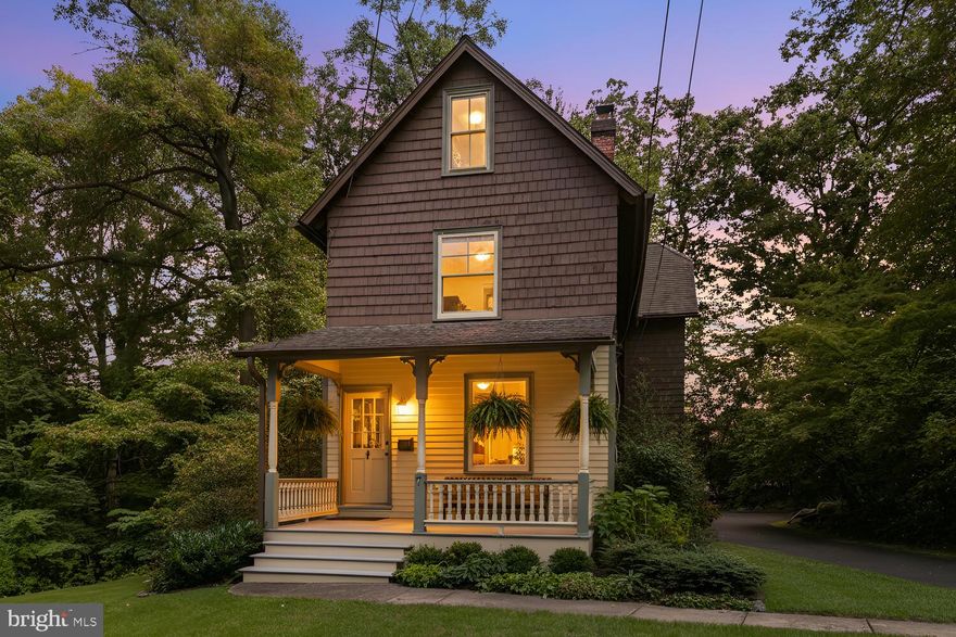Known locally as the “Gardener’s Cottage,” 7 Walt Lane is located in the Wyncote Historic District. Constructed in 1900, this charming home was one of the original buildings of the Henry Walt estate. In 2009 the home was restored and significantly enlarged. Reimagined in consultation with the local board of historical review, the house now comprises over 2000 square feet, including four bedrooms, two full bathrooms and a first-floor powder room. A large, three-floor (plus basement) addition, essentially doubling the size of the original house, incorporates a first-floor kitchen and family room, second-floor master suite, and third-floor bedroom. The open first floor has original pine floors throughout the living and dining room. Sight lines lead from the original front porch entrance (porch restored 2022) to the rear French doors, opening to a large wraparound rear porch. The functional kitchen has a large breakfast bar, subway-tiled backsplash, solid surface counters, white cabinets and stainless steel appliances. The kitchen is open to a comfortable family room, perfect for entertaining. The large primary suite occupies the second floor of the newer addition. There is a generous walk-in closet, and the primary bath includes a double vanity and tiled shower. Second-floor laundry includes a stacked washer and dryer (installed 2025). An additional bedroom with windows on three sides and a second full bath complete this floor.  The third floor includes a large third bedroom with dormered windows, together with a cozy fourth bedroom or office space. Careful attention to period detail includes cedar shake exteriors and two-over-two Pella windows, complementing those original to the house. A stunning covered porch wraps around the rear of the first floor, overlooking the landscaped yard and adjacent Robinson Park. Also included are newer heating and cooling systems (installed 2022 and 2024) and a finished bonus room in the walk-out basement.  Located on a relatively quiet street, 7 Walt Lane offers a large, private wooded lot, paved driveway with ample parking, original storage barn, easy access to township parks and walking distance to the unmatched Jenkintown/Wyncote SEPTA station.